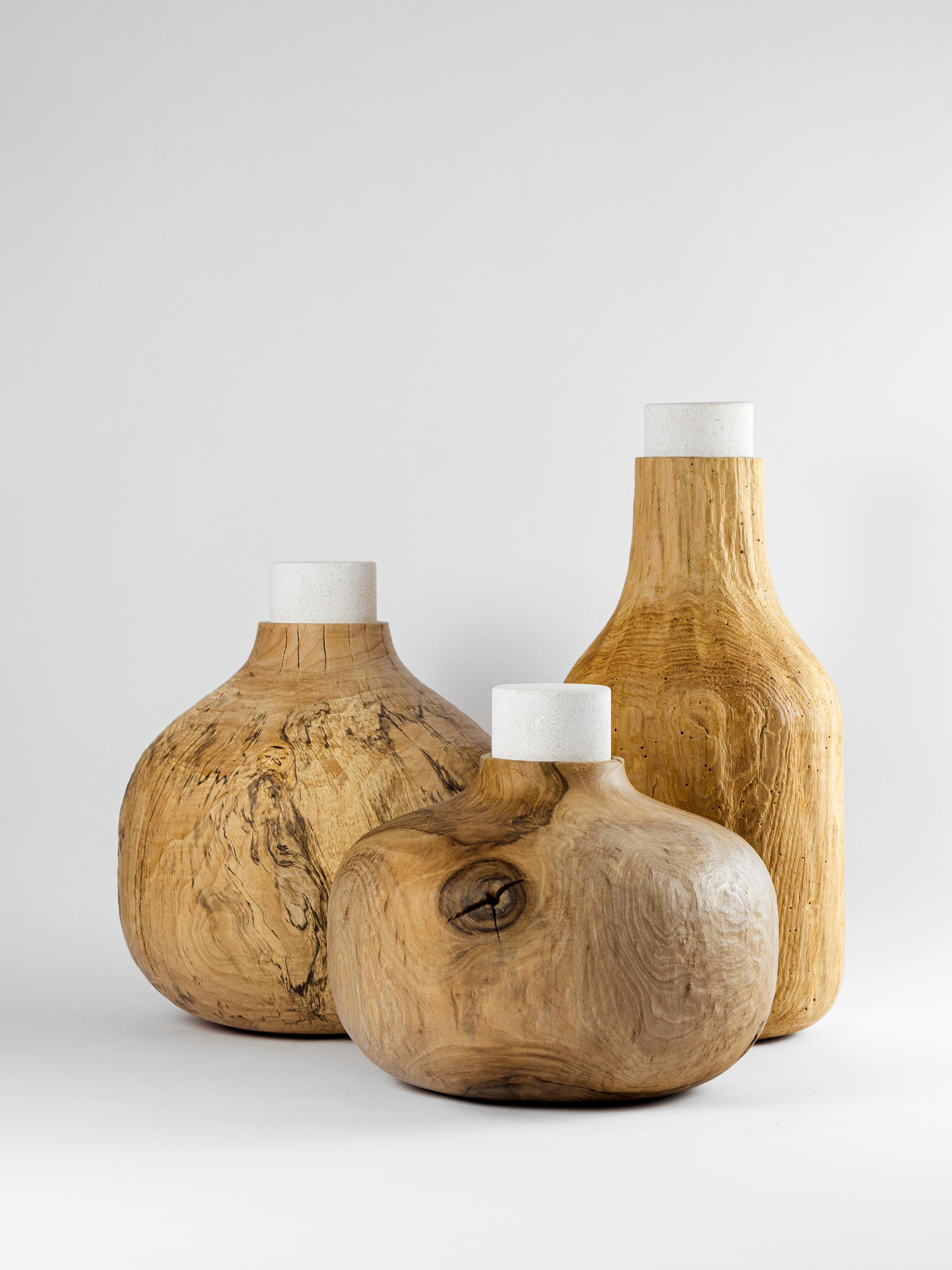 A collection of vases in Vicentina Stone and wood of Walnut, Beech, Alder and Chestnut that comes from the theme of the 