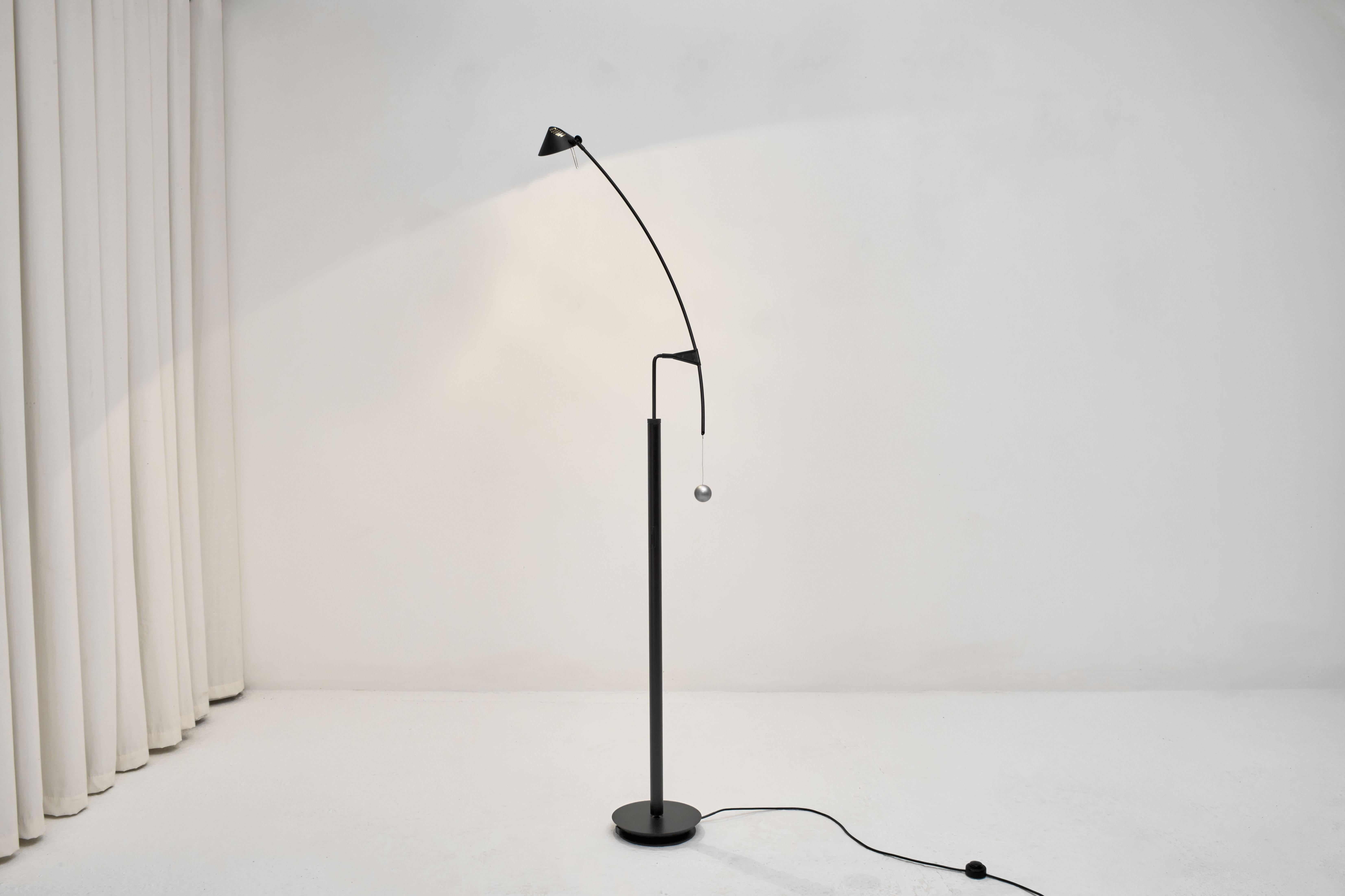 The Nestore Lettura floor lamp was designed by Carlo Forcolini for Artemide, circa 1991. Rotating 180º on the vertical axis and 90º on the horizontal, the shade is also rotates. There is a counter weight at one end which perfectly balances the