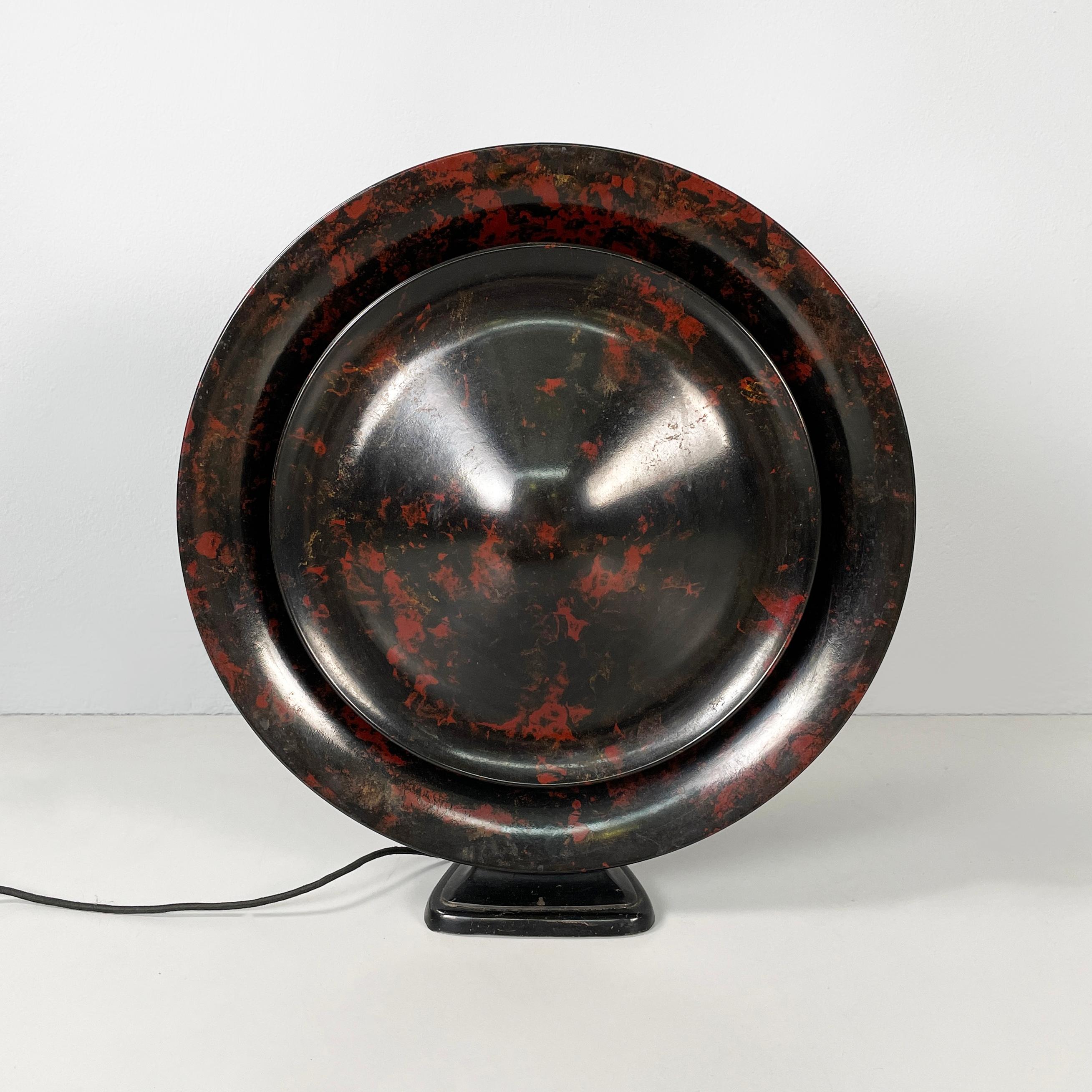 Netherlands Black and red bakelite speaker by Louis Kalff for Philips, 1930s
Round iconic bakelite tabletop audio speaker painted black with red spots. The triangular base of the speaker is made of bakelite-coated metal. 
Produced by Philips in
