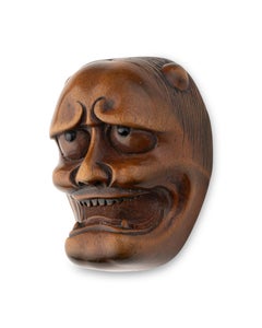 Netsuke in carved boxwood in the form of a nō theatre mask of Hannya