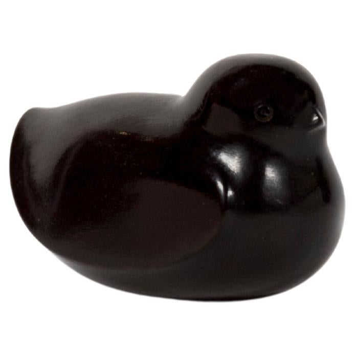 Netsuke in persimon wood in the form of a sparrow