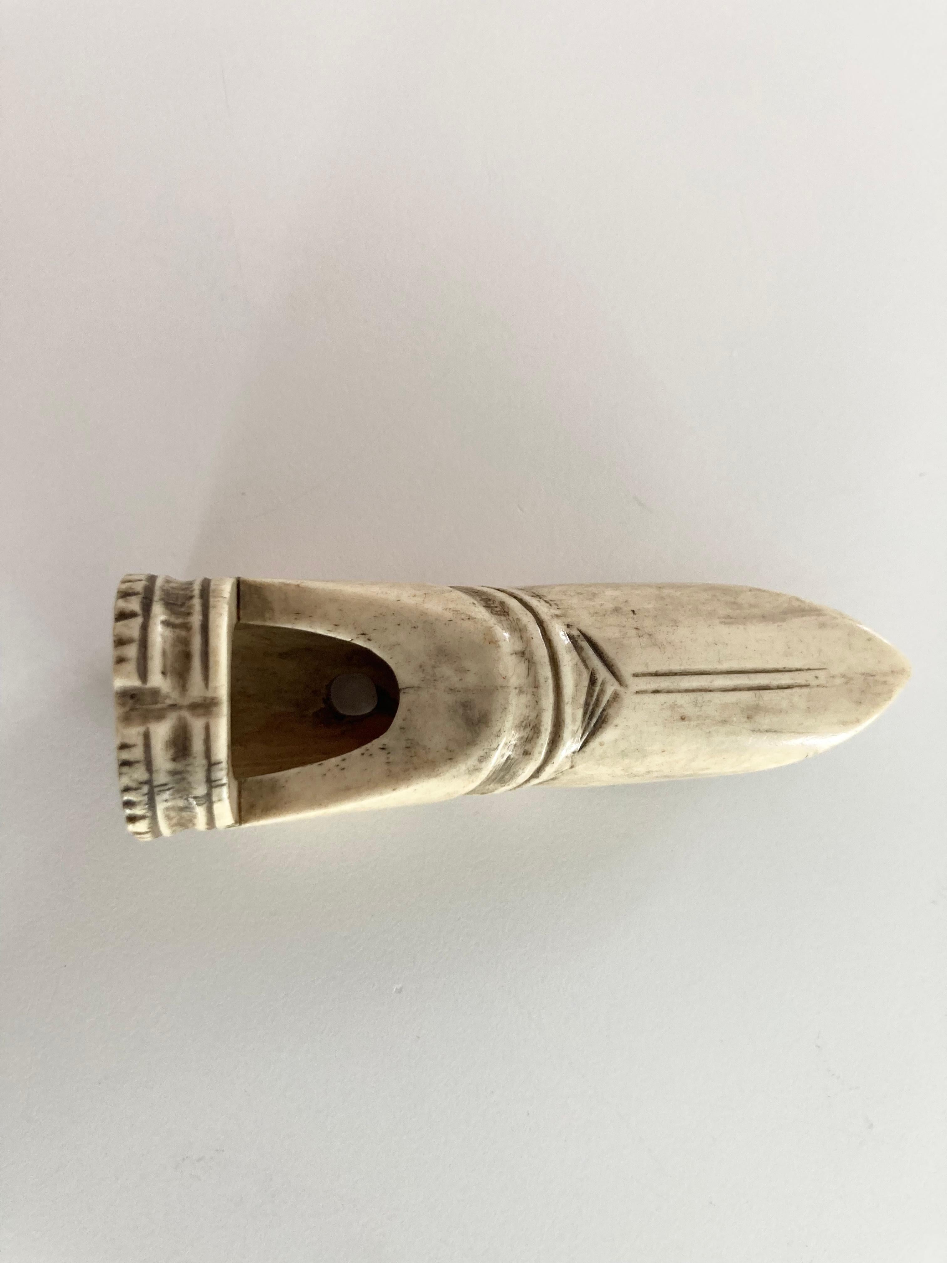 Un grand Netsuke en bois de cerf bien sculpté avec dans une forme fine et réaliste d'un sifflet traditionnel en bambou. D'une forme typiquement japonaise, le Netsuke présente des détails incisés, un trou unique et une sensation fantastique lorsqu'on