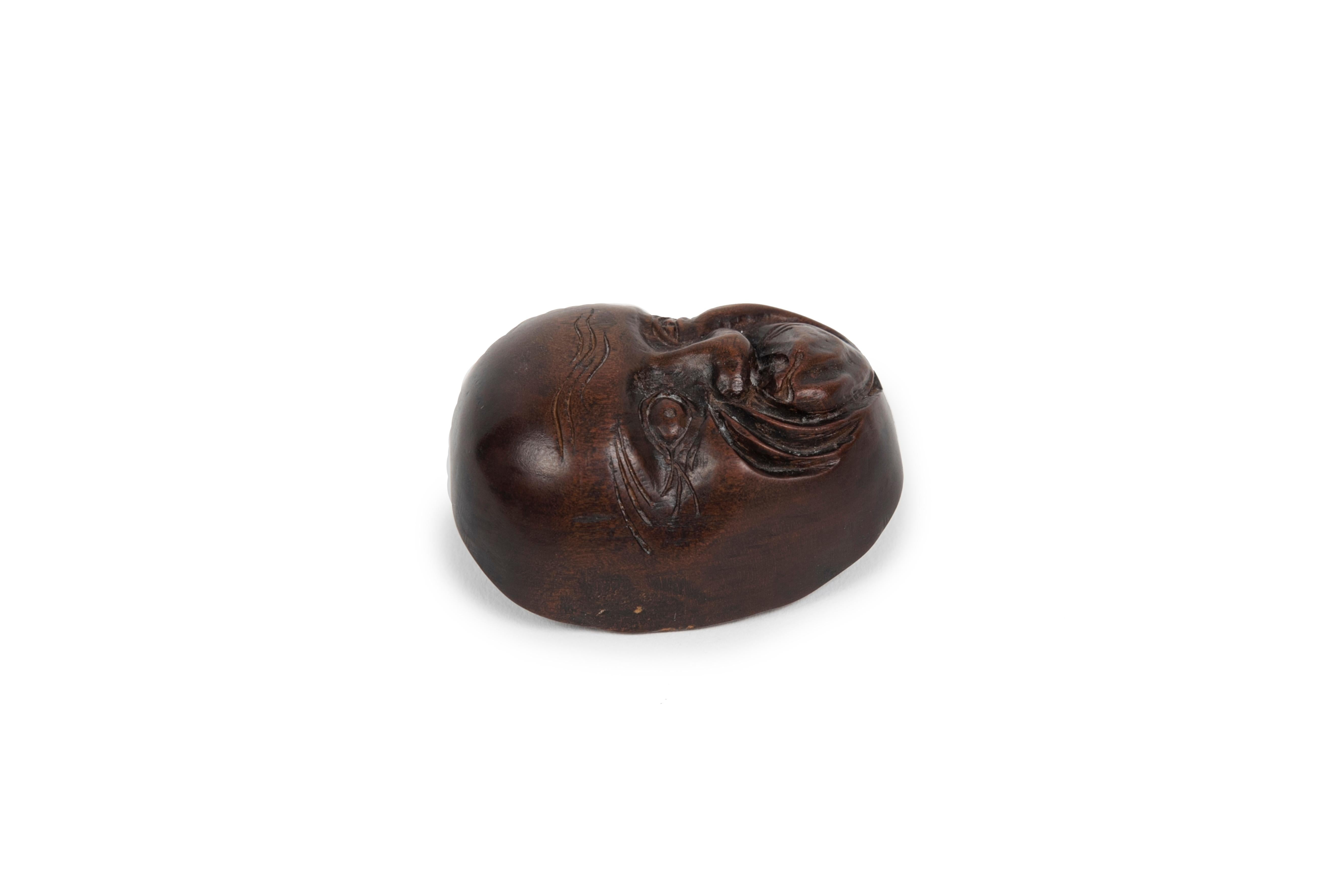 Japanese Netsuke in the form of a No mask representing the character of Hyottoko For Sale