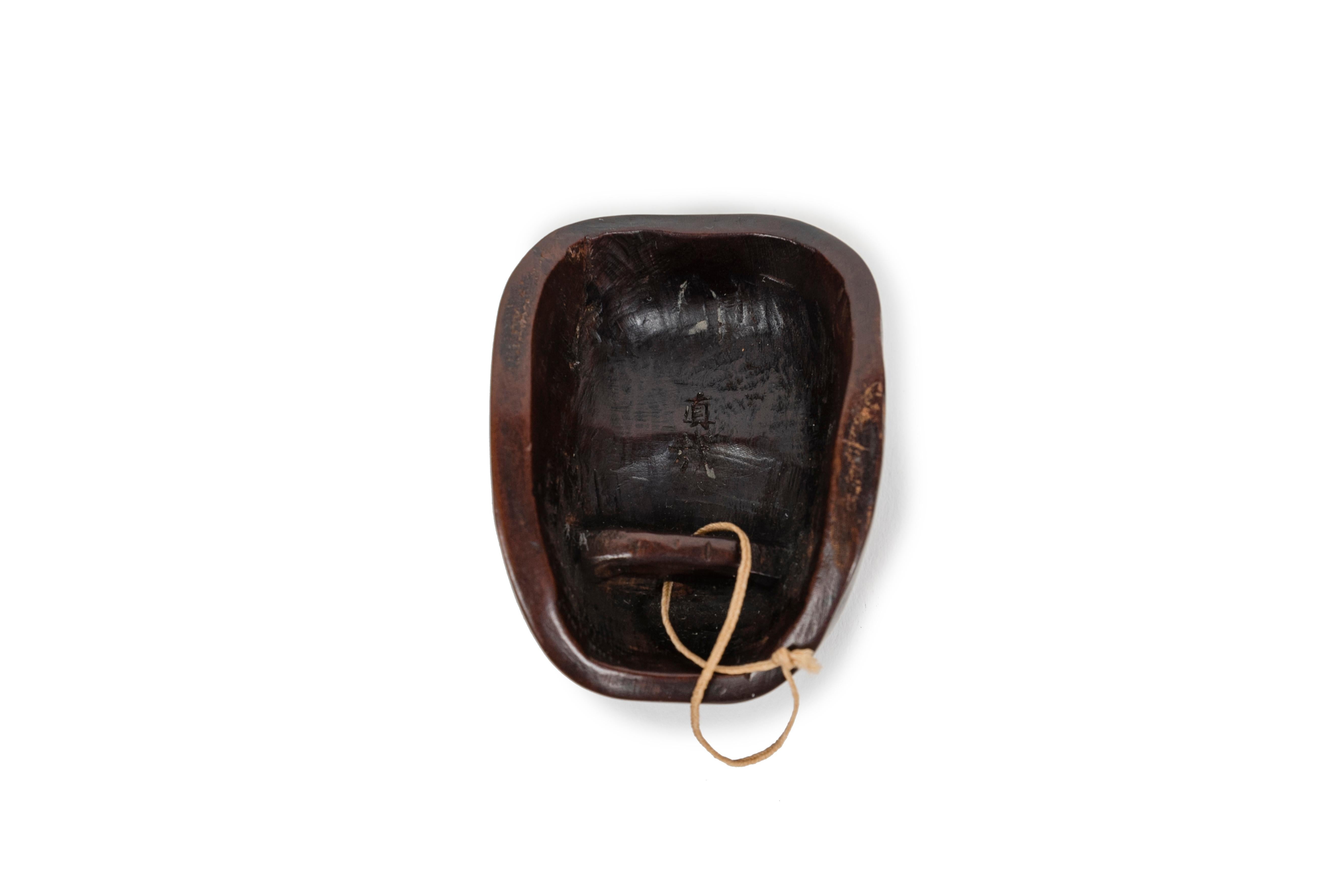 Carved Netsuke in the form of a No mask representing the character of Hyottoko For Sale