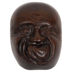 Netsuke en forma de máscara No que representa al personaje de Hyottoko