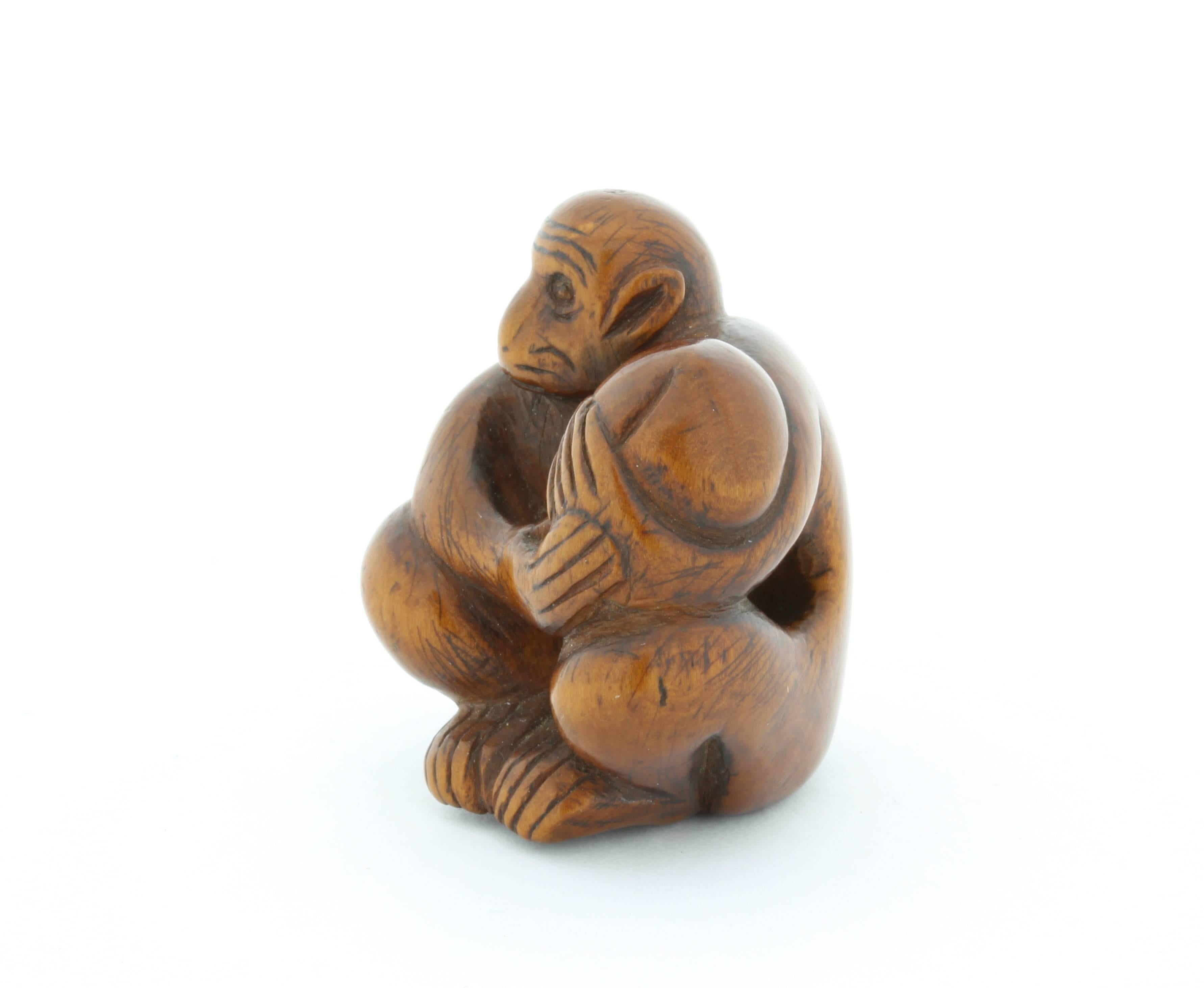 This netsuke is made entirely out of wood and depicts a monkey holding a peach. A peach is a symbol of longevity and it is said to get rid of devil spirit. Unusually for a netsuke there is only one hole at the bottom and supported hole on one side,