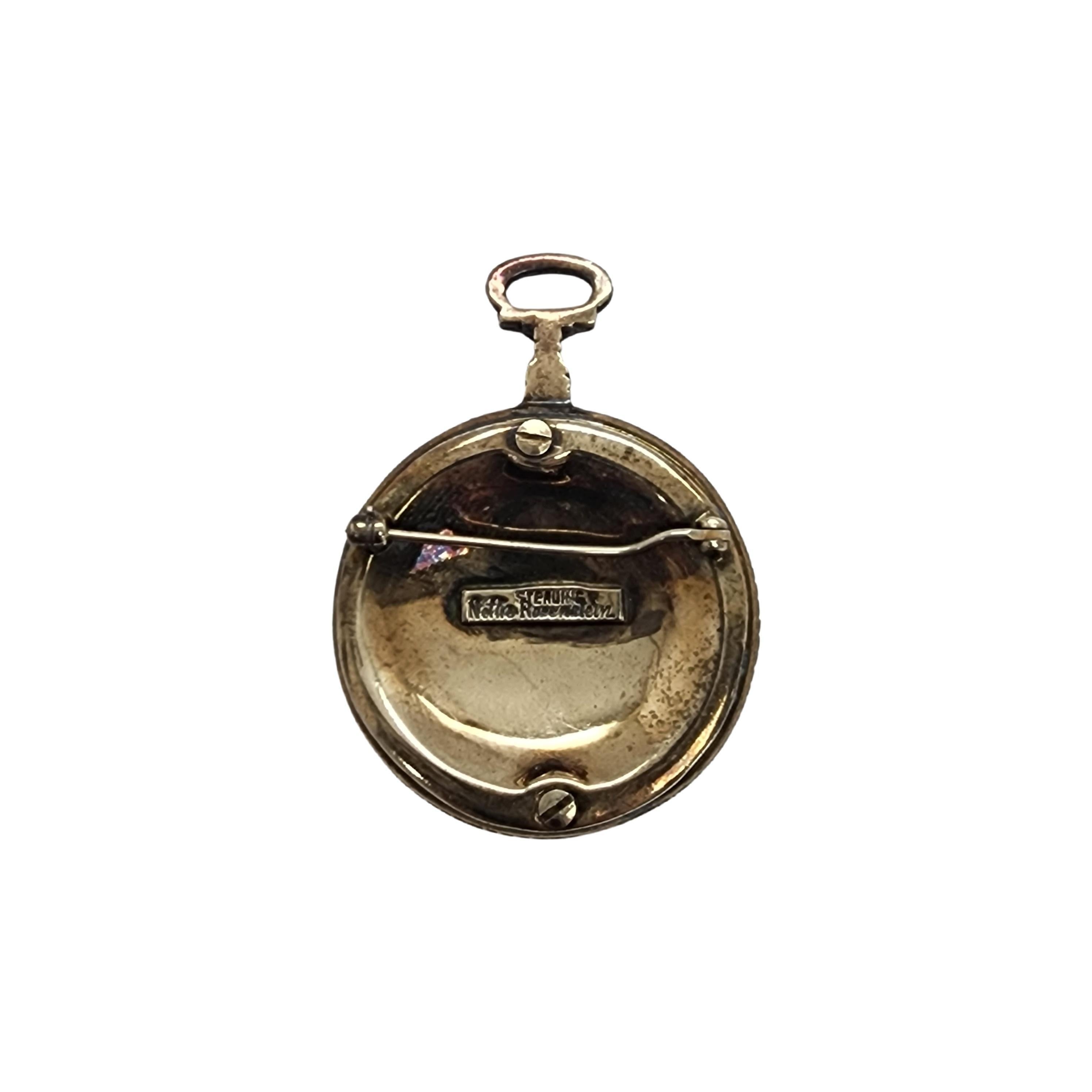 Gold vermeil over sterling silver flower watch fob pin by designer Nettie Rosenstein.

Beautifully detailed flower print is at the center of this watch fob design pin with clear and blue crystals surrounding the print set in gold vermeil sterling