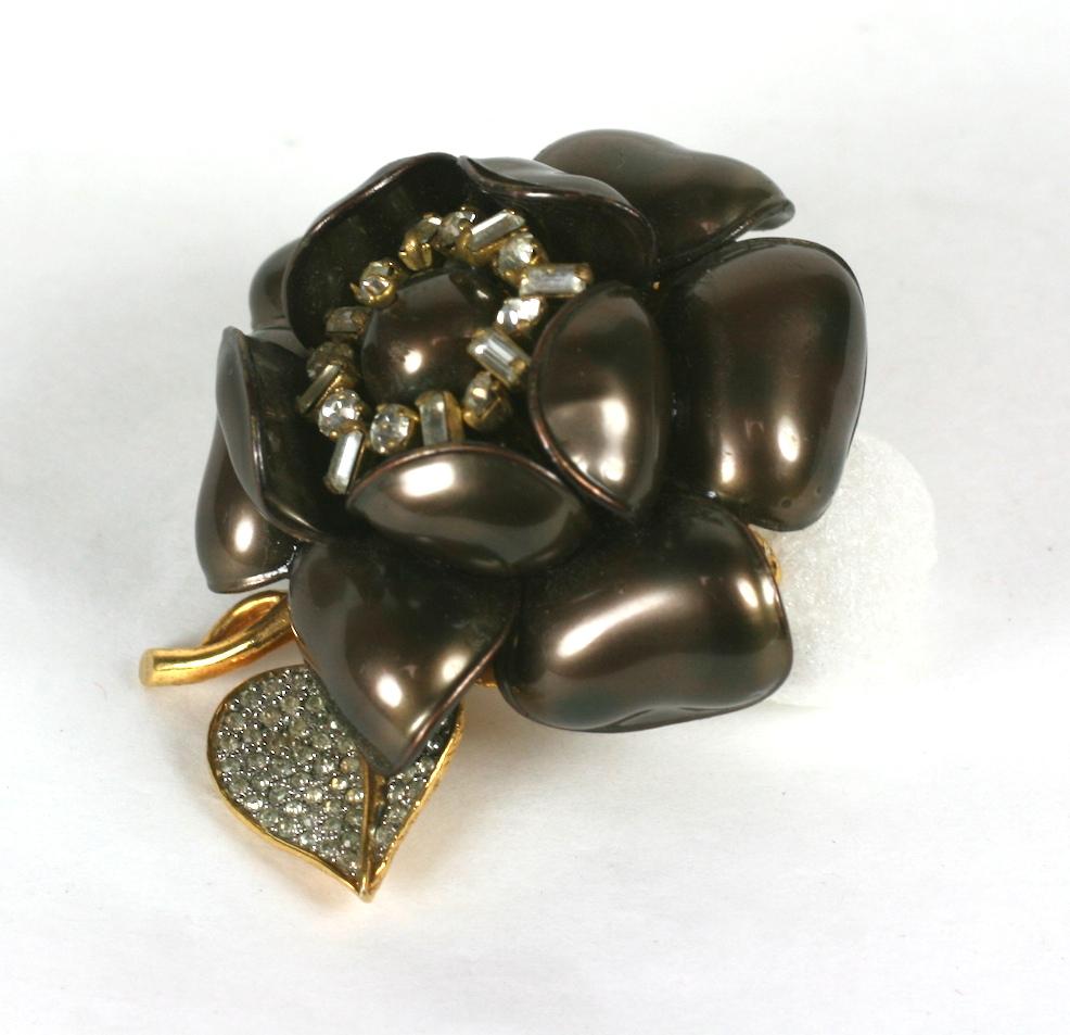 Rare and unusual Nettie Rosenstein Gripoix Flower Brooch.  Designed in USA, made in France with a pearlized poured glass flower by Maison Gripoix.  Attractive dimensional design with paste cluster and faux pearl center. Leaf decorated with fine pave