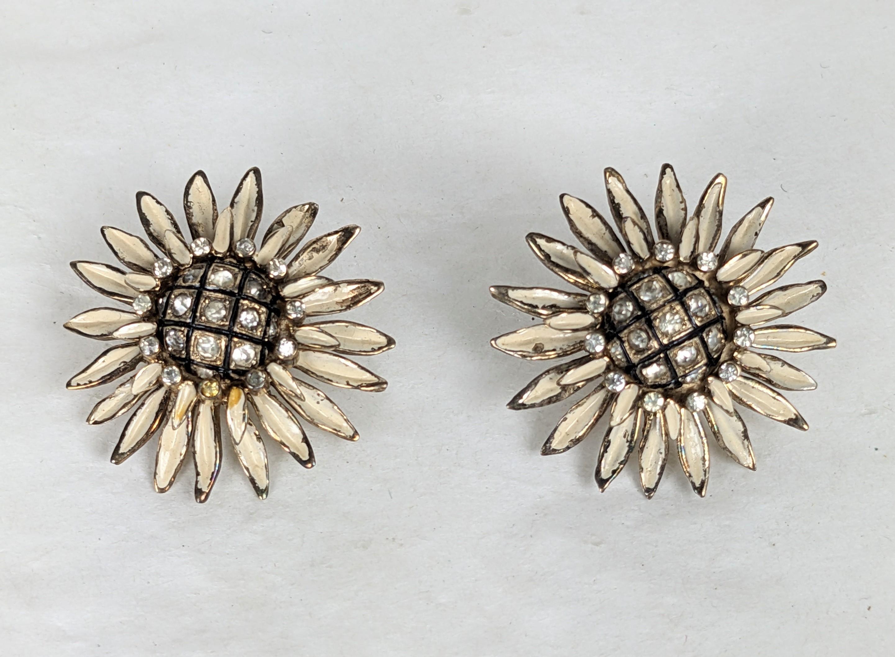 Nettie Rosenstein Retro Sunflower ear clips. Of rose gold plated sterling silver, white and black cold enamel and crystal rhinestone pave. Clip back fittings. Minor wear to enamel. 1940's USA. 
L 1 1/8