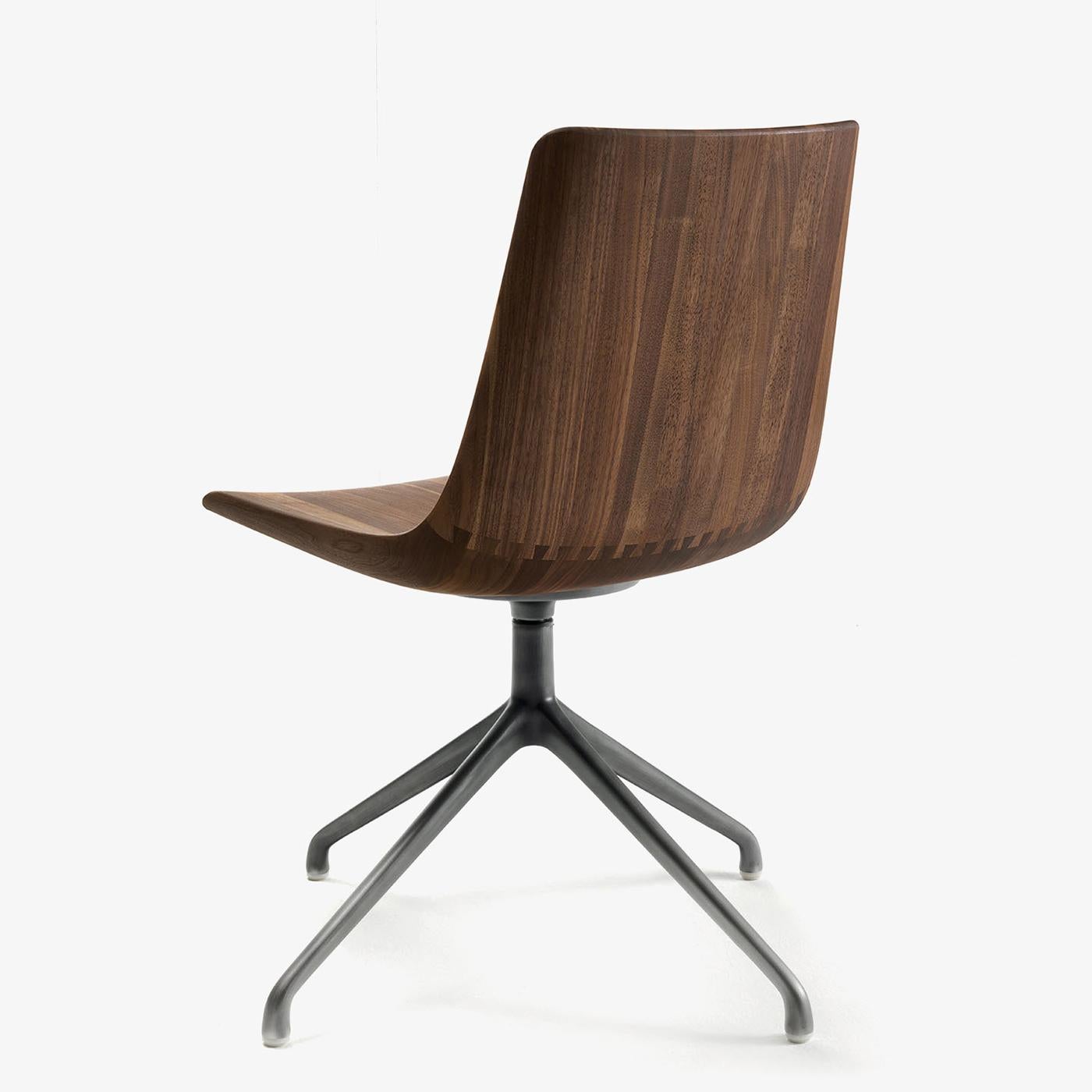 Chair Neutra in solid walnut wood,
back and seat jointed through dovetail joints.
With swivel steel base in lacquered irondust finish. 
Wood treated with natural pine extracts wax.
Also available in solid oak on request.