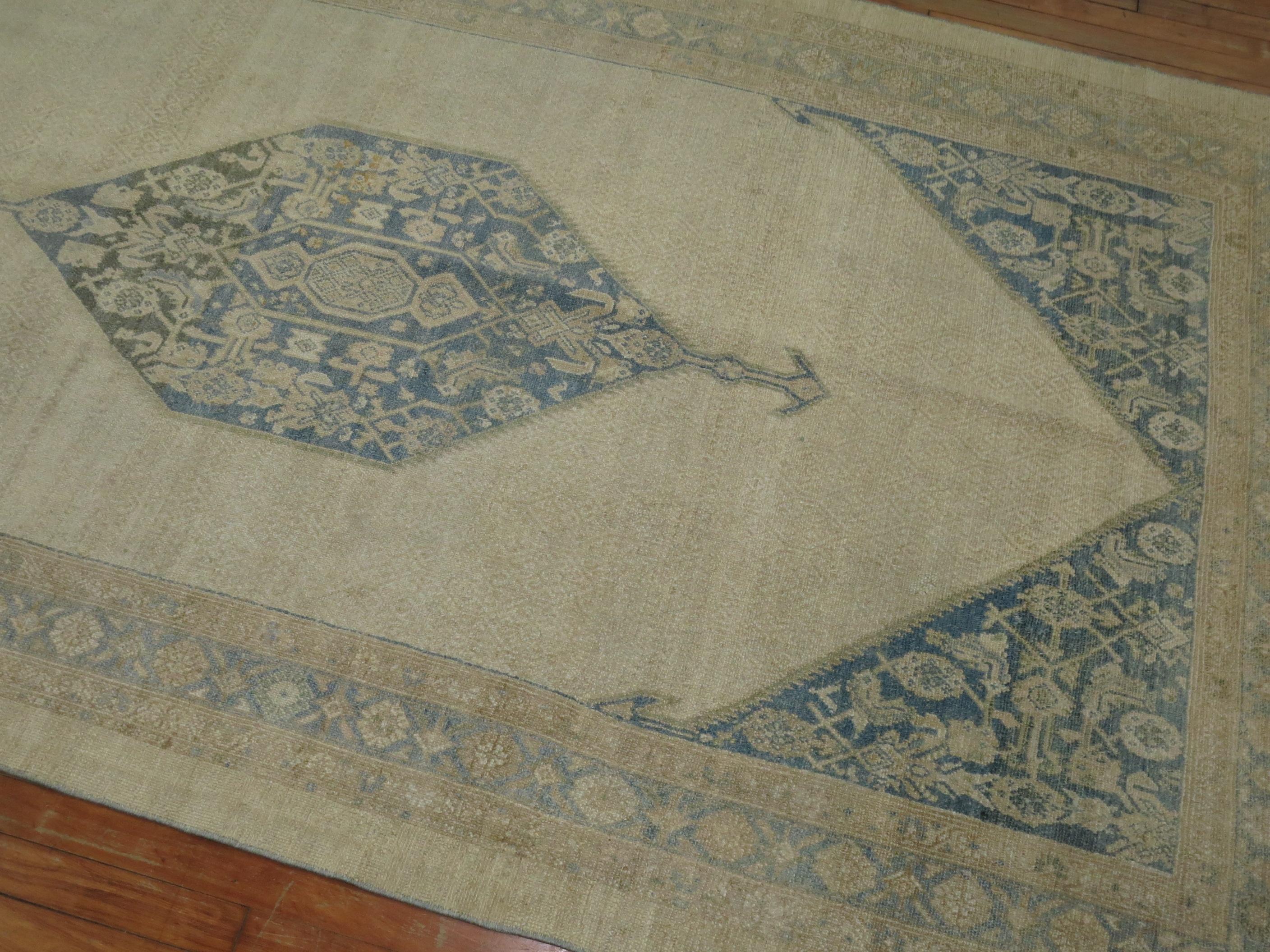 An authentic early 20th century Persian Serab gallery rug with a large soft blue central medallion set on a khaki field.

Measures: 5'1