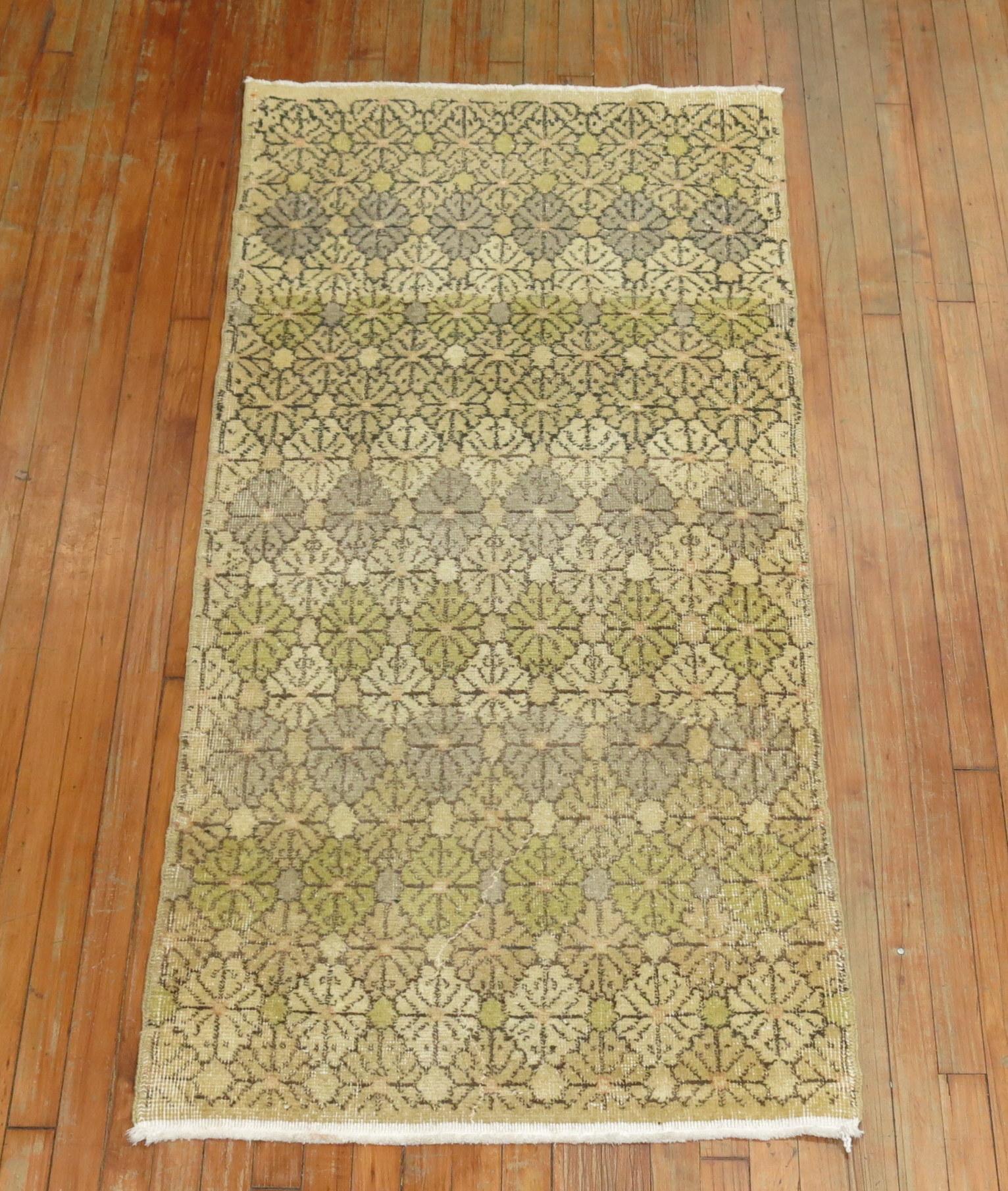 Neutral colored Turkish deco wide runner from the mid-20th century with an all-over repetitive design. Beige, tans, brown, light green accents, circa mid-20th century.

Measures: 2'10” x 6'.
