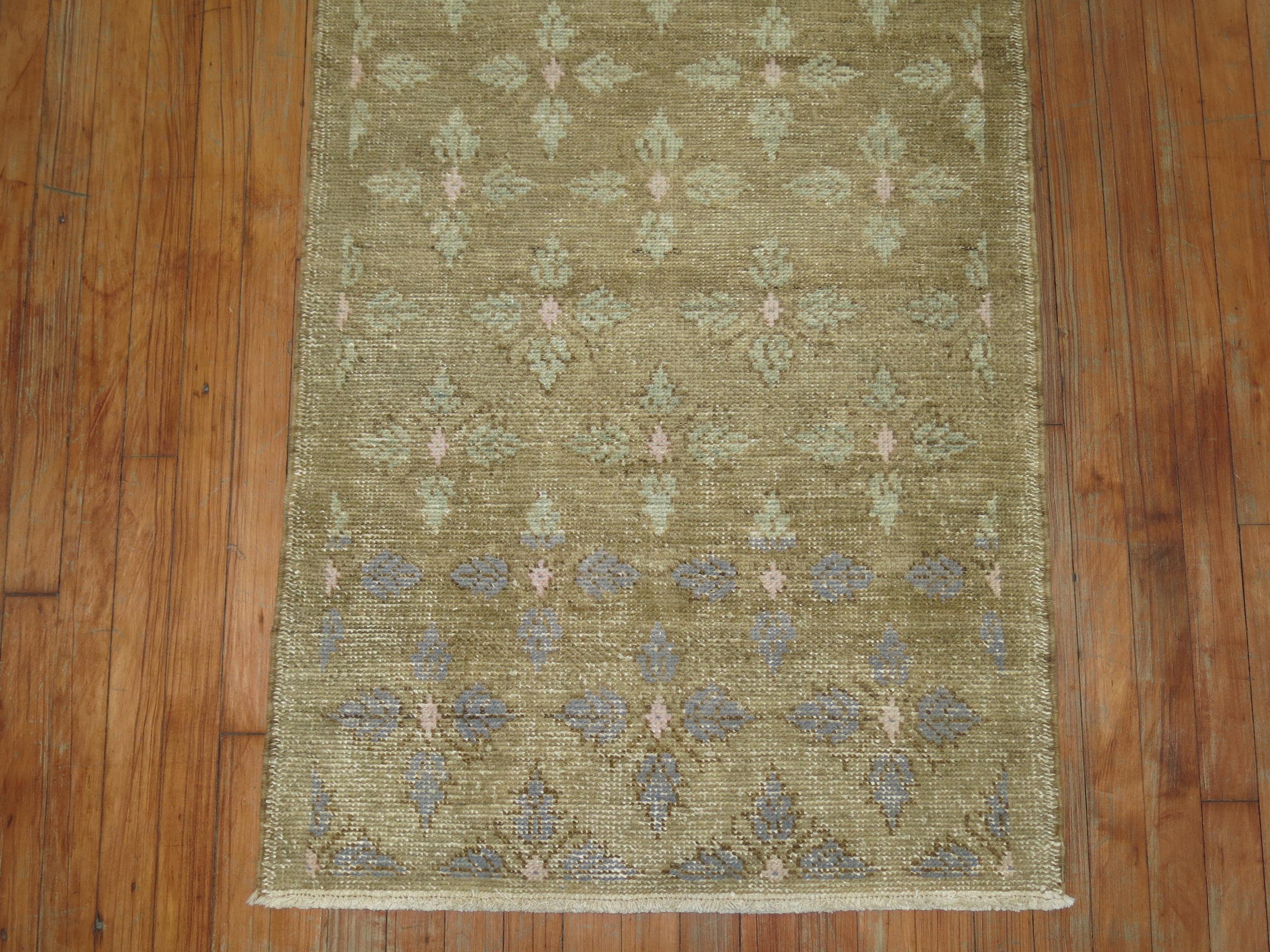 A mid-20th century tribal Turkish scatter size rug with pink, periwinkle, light green accents on a muddy brown ground

Measures: 2'7