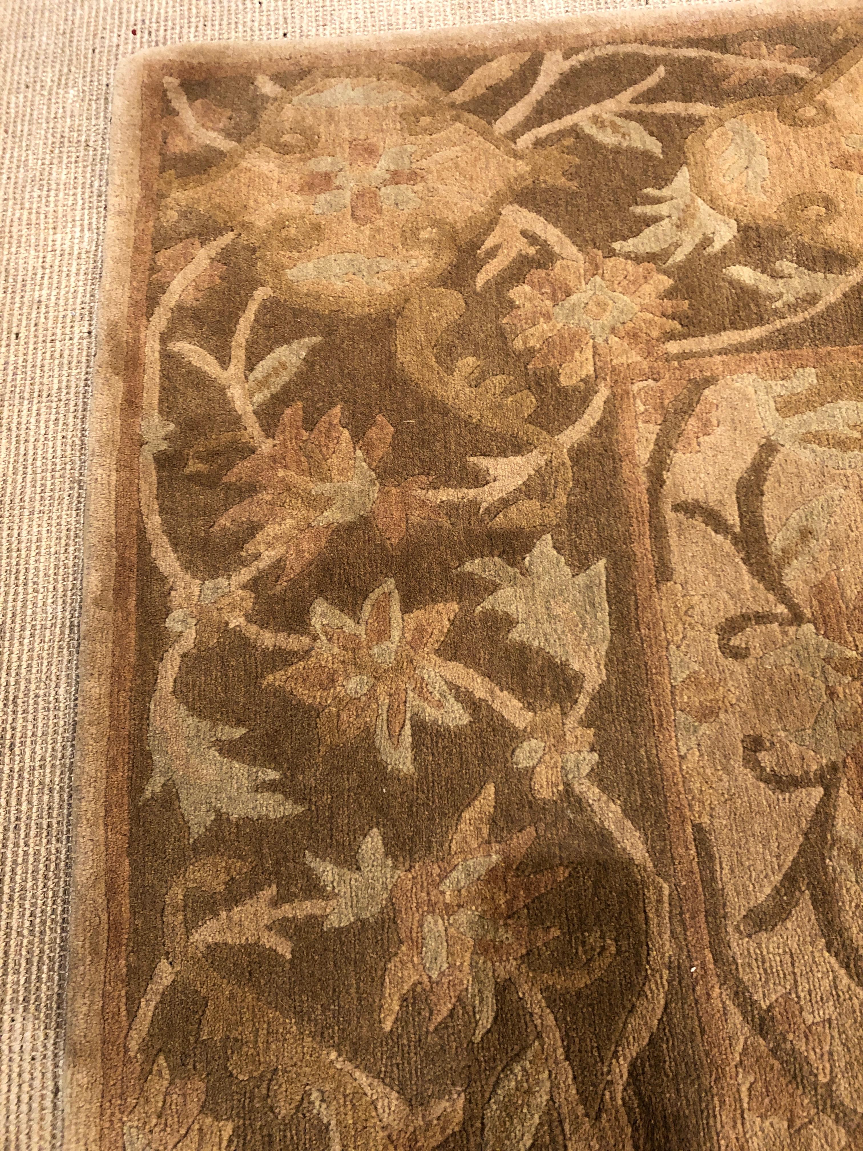 A beautiful silk Tibetan area rug in shades of camel, cream and brown with wonderful pattern.