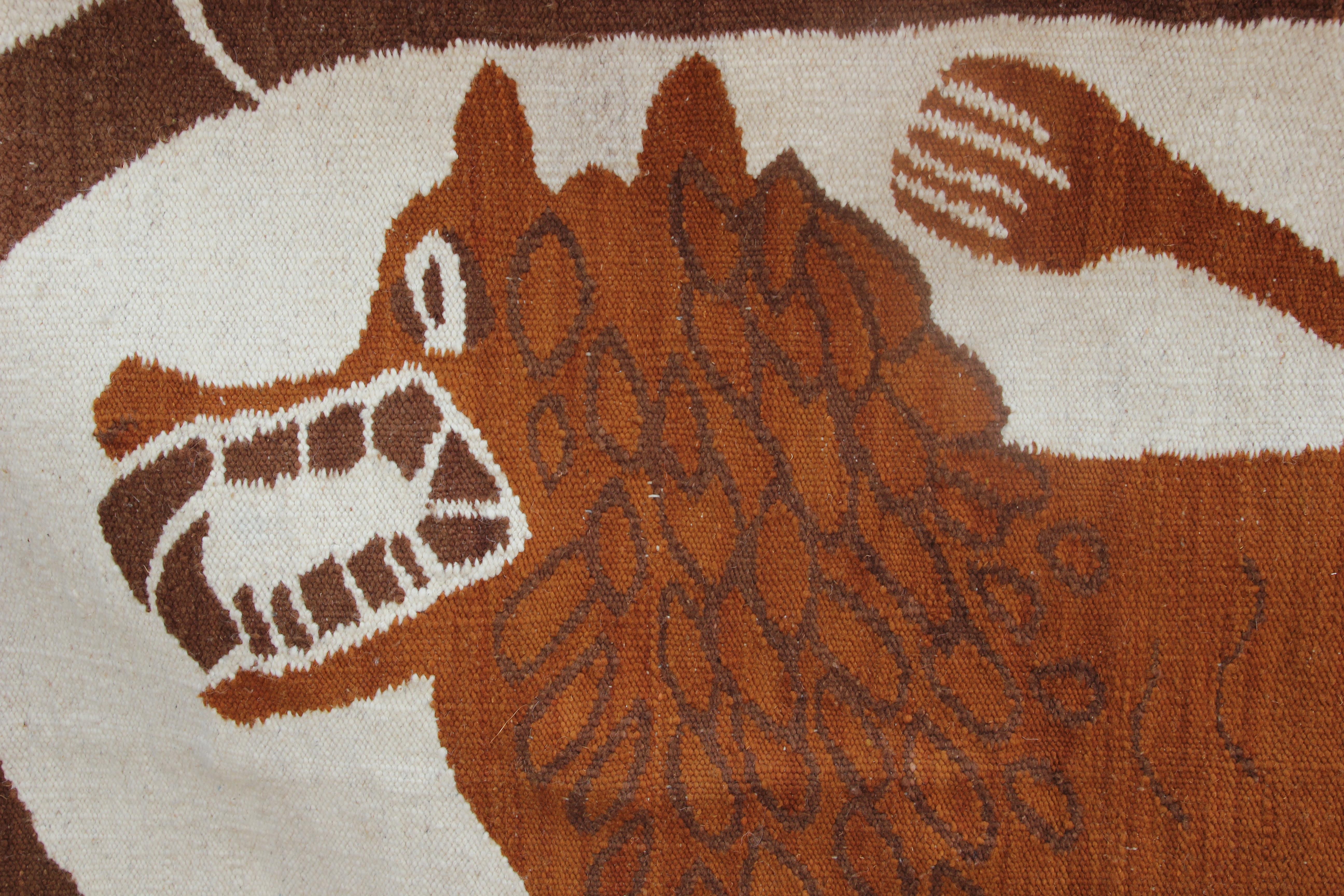 Neutral tonal brown and white folk style tapestry with a lion. The work is embordered stamped by the artist in the bottom corner.