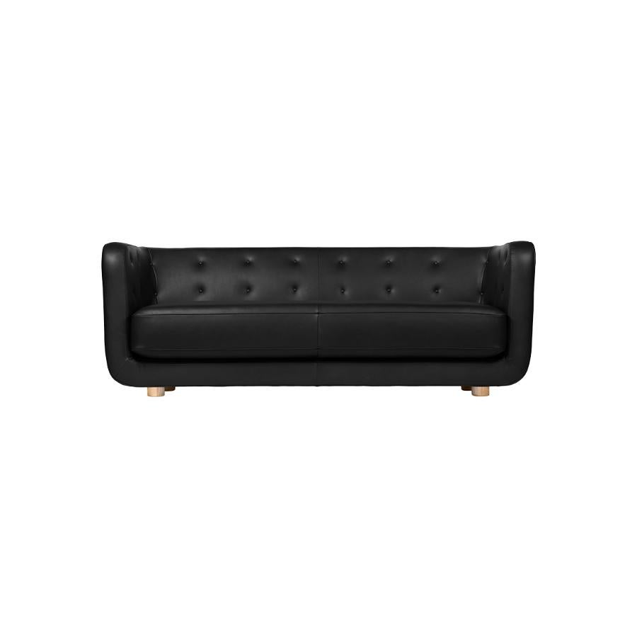 Nevada black leather and natural oak Vilhelm sofa by Lassen
Dimensions: W 217 x D 88 x H 80 cm 
Materials: leather, oak.

Vilhelm is a beautiful padded three-seater sofa designed by Flemming Lassen in 1935. A sofa must be able to function in