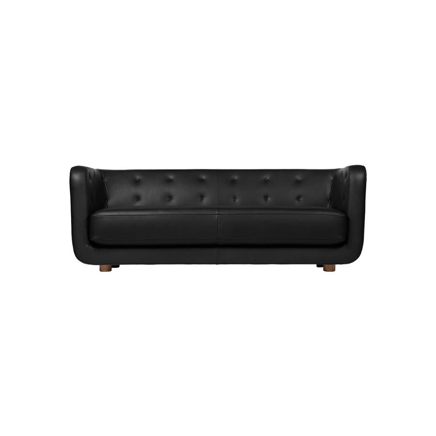 Nevada black leather and smoked oak vilhelm sofa by Lassen
Dimensions: W 217 x D 88 x H 80 cm 
Materials: leather, oak.

Vilhelm is a beautiful padded three-seater sofa designed by Flemming Lassen in 1935. A sofa must be able to function in