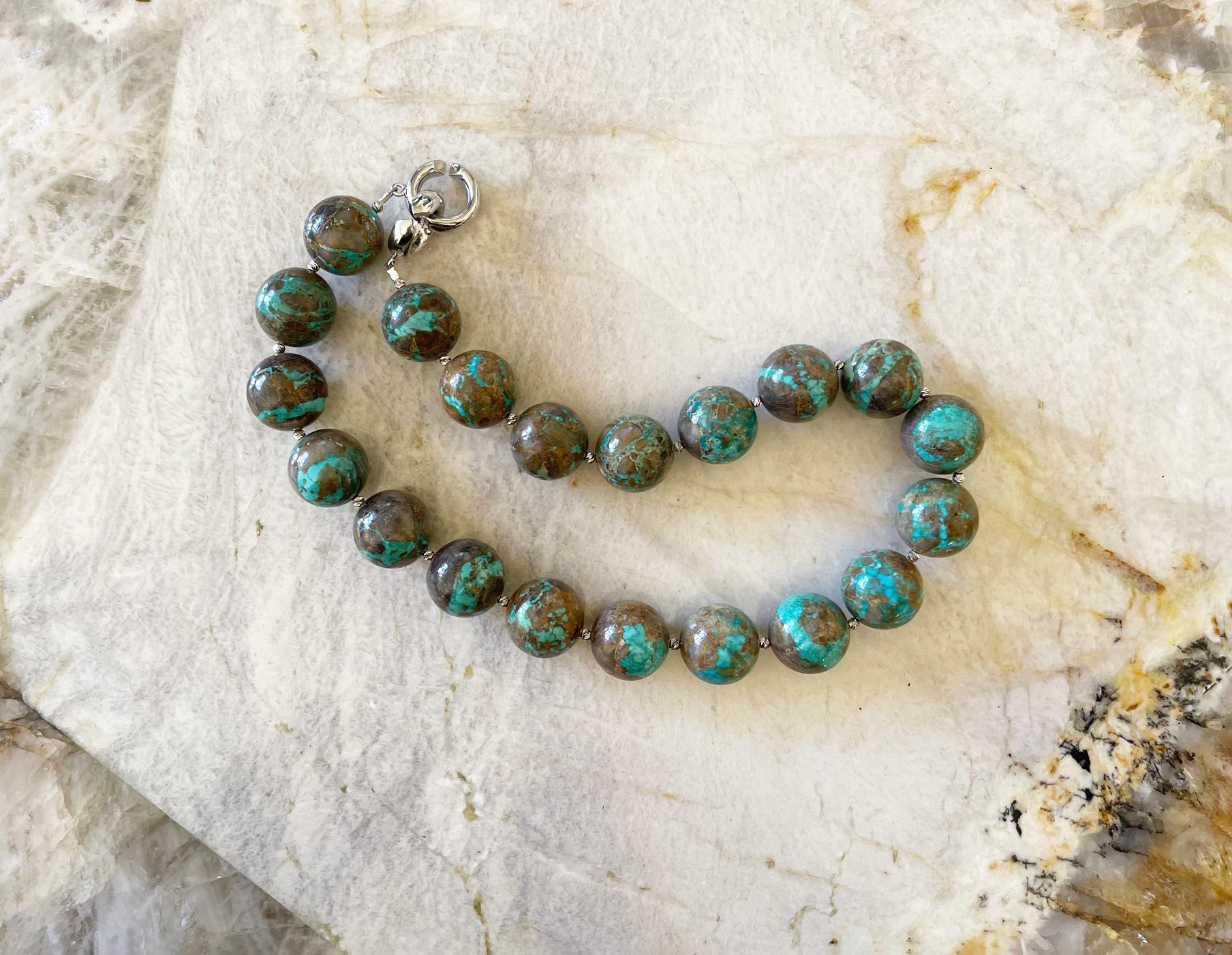 Gorgeous necklace made with very rare Nevada Carico Lake 20mm round turquoise beads, tiny sterling silver accent beads, and finished with an elegant interlocking clasp. This necklace measures 19 inches (48.3 cm) long including the clasp. The