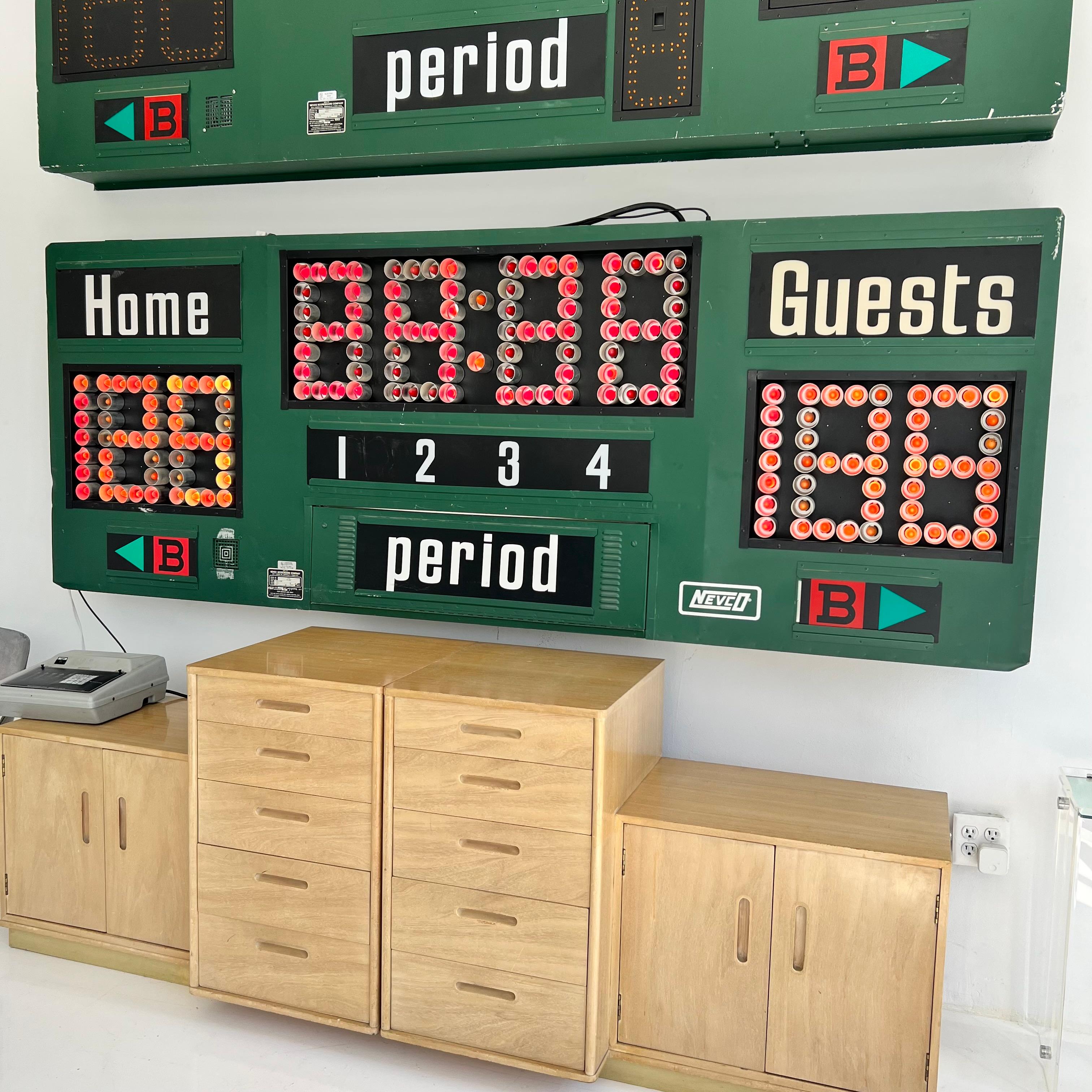 Fantastic green metal scoreboard by Nevco. Made in the 1990s in the US. Can be used for multiple sports. 100% functional and gone through. Running clock, guest and home score and bonus. The clock section uses red Christmas light bulbs. All other