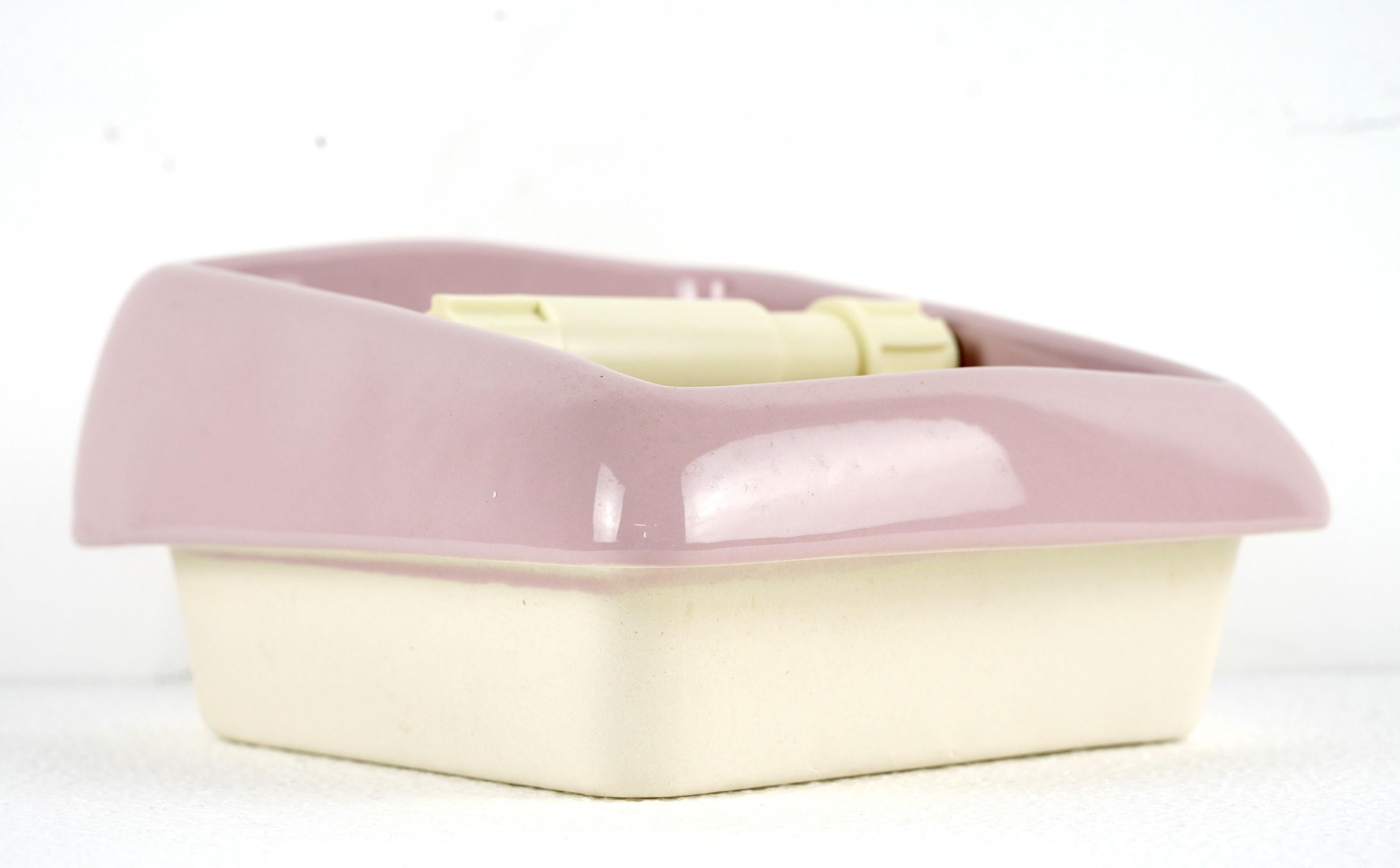 20th century New old stock, meaning never used, ceramic pink recessed toilet paper holder with a cream colored roller. 1 Piece. Please note, this item is located in our Scranton, PA location.