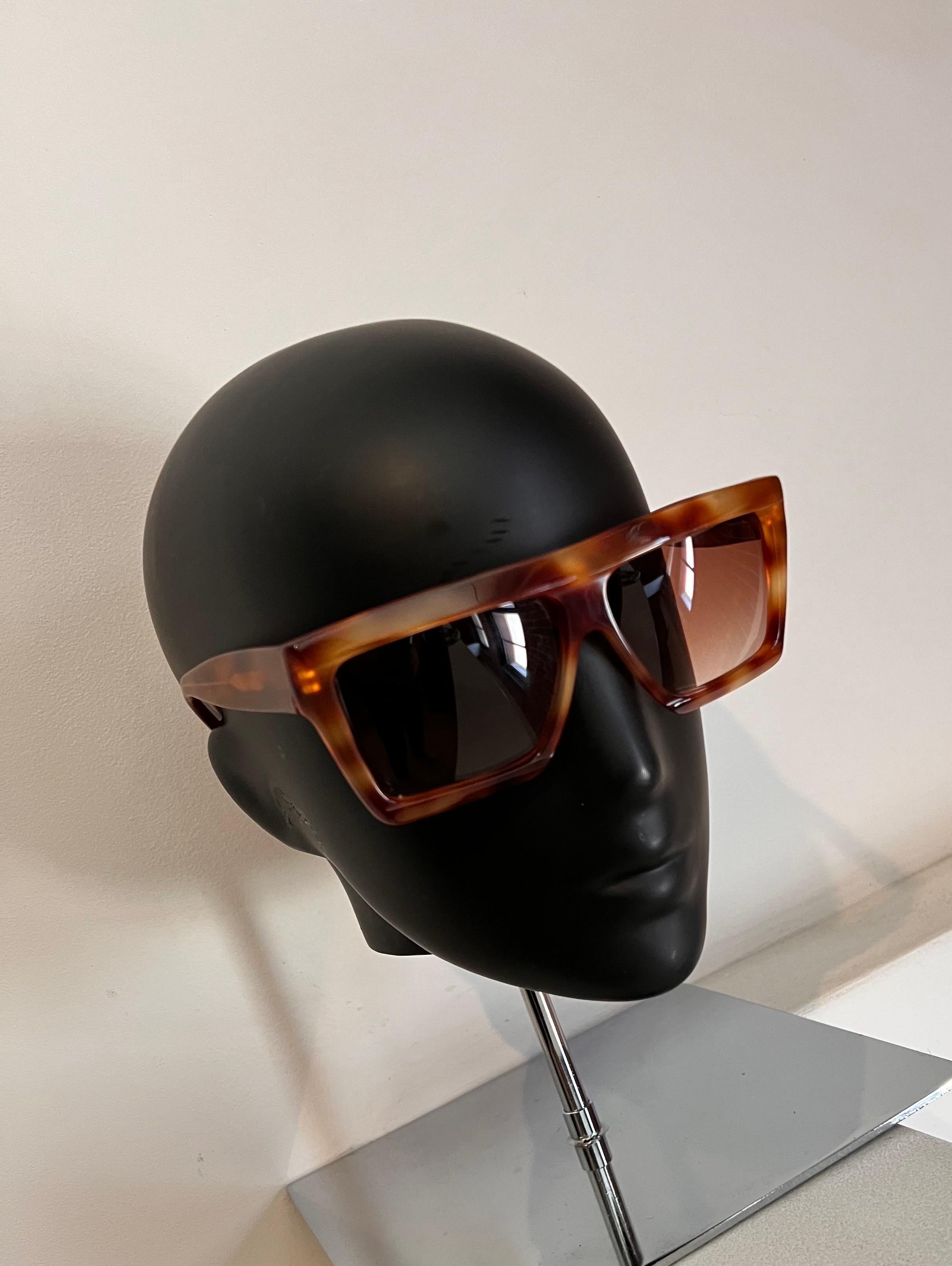Super cool and stylish, rare and unique Andre Courreges 1980’s sunglasses. 
Square style tortoiseshell frame with gold accent holding a spotless pair of tan lenses.

New, never worn or displayed. One of a kind piece of eyewear history.

This pair is