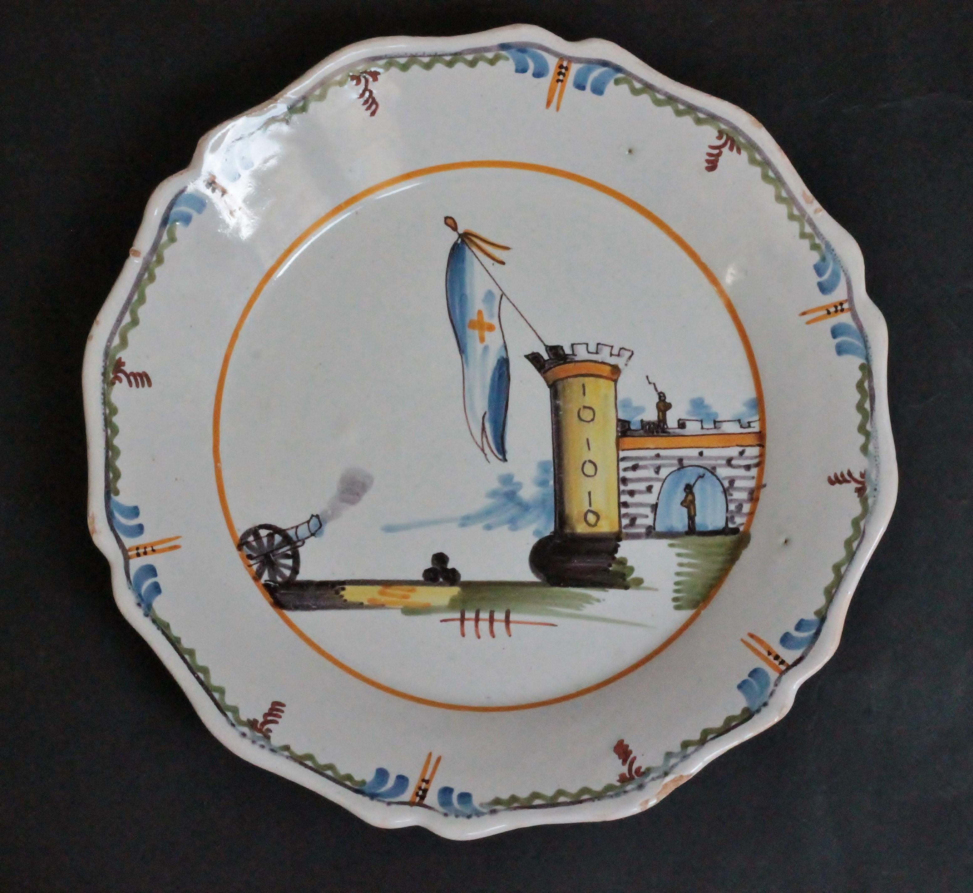 A Nevers (France) faience plate with a polychrome decoration of revolutionary period, the storming of the Bastille,
18th century.
Measures: Diameter 23 cm; height 3.4 cm.
Several losses to the glaze around the rim.
Cf. Collection L. Heitschel N°