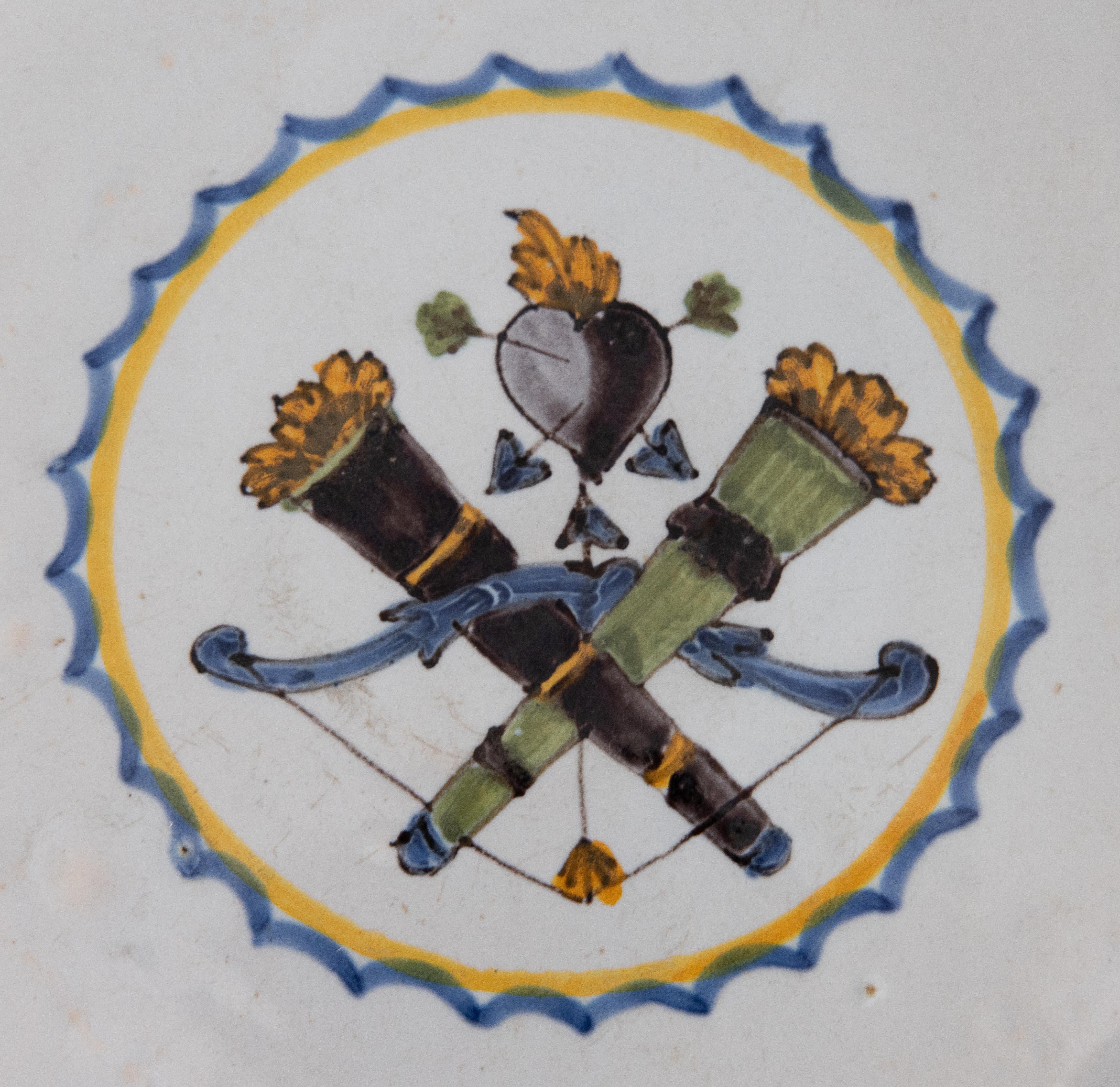 A wonderful 18th century Nevers polychrome plate featuring a striking hunting trophy. Hand painted in vibrant blue, yellow, green and aubergine with a decorated border on the scalloped rim.