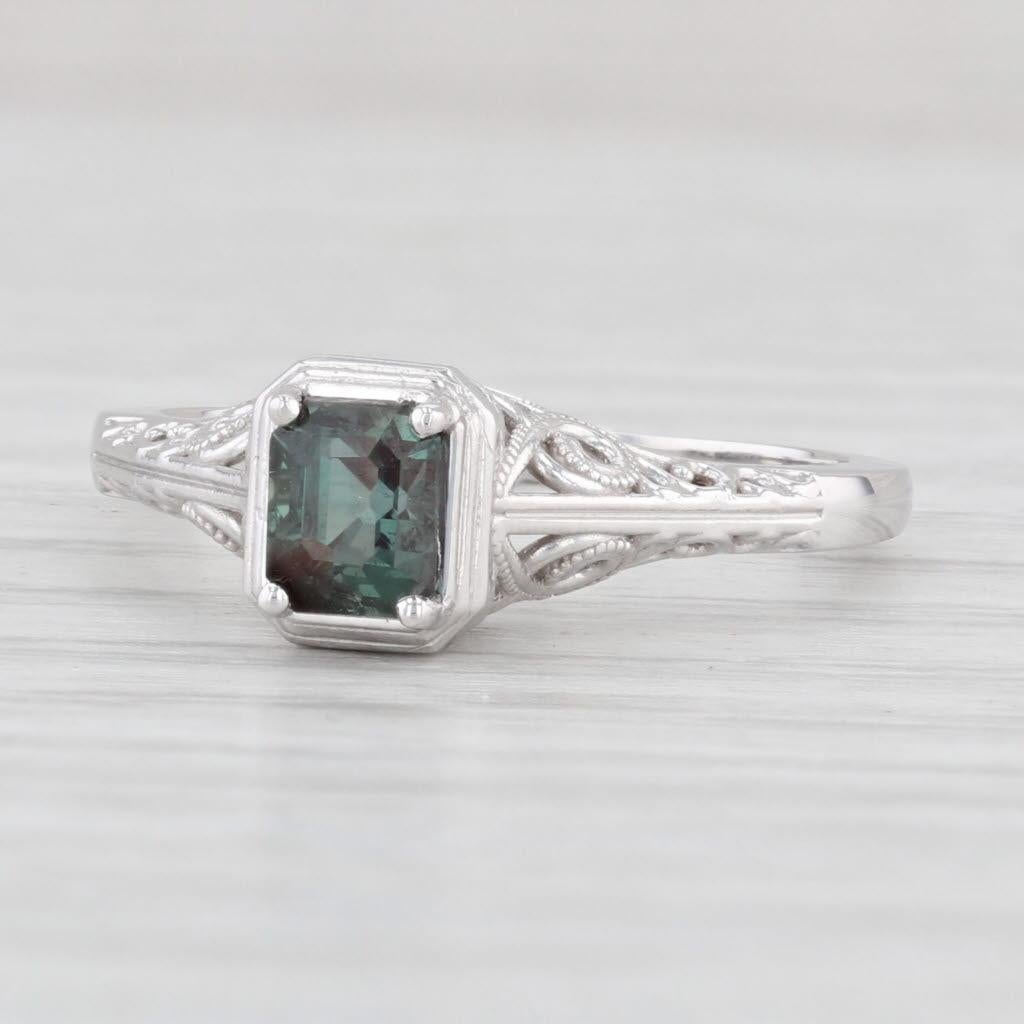 Gemstone Information:
*Natural Alexandrite*
Total Carats - 0.70ct
Cut - Emerald
Color - Dark Green

Metal: 14k White Gold
Weight: 2.7 Grams 
Stamps: 14k
Face Height: 7 mm 
Rise Above Finger: 7.2 mm
Band / Shank Width: 1.5 mm

This ring is a size 6