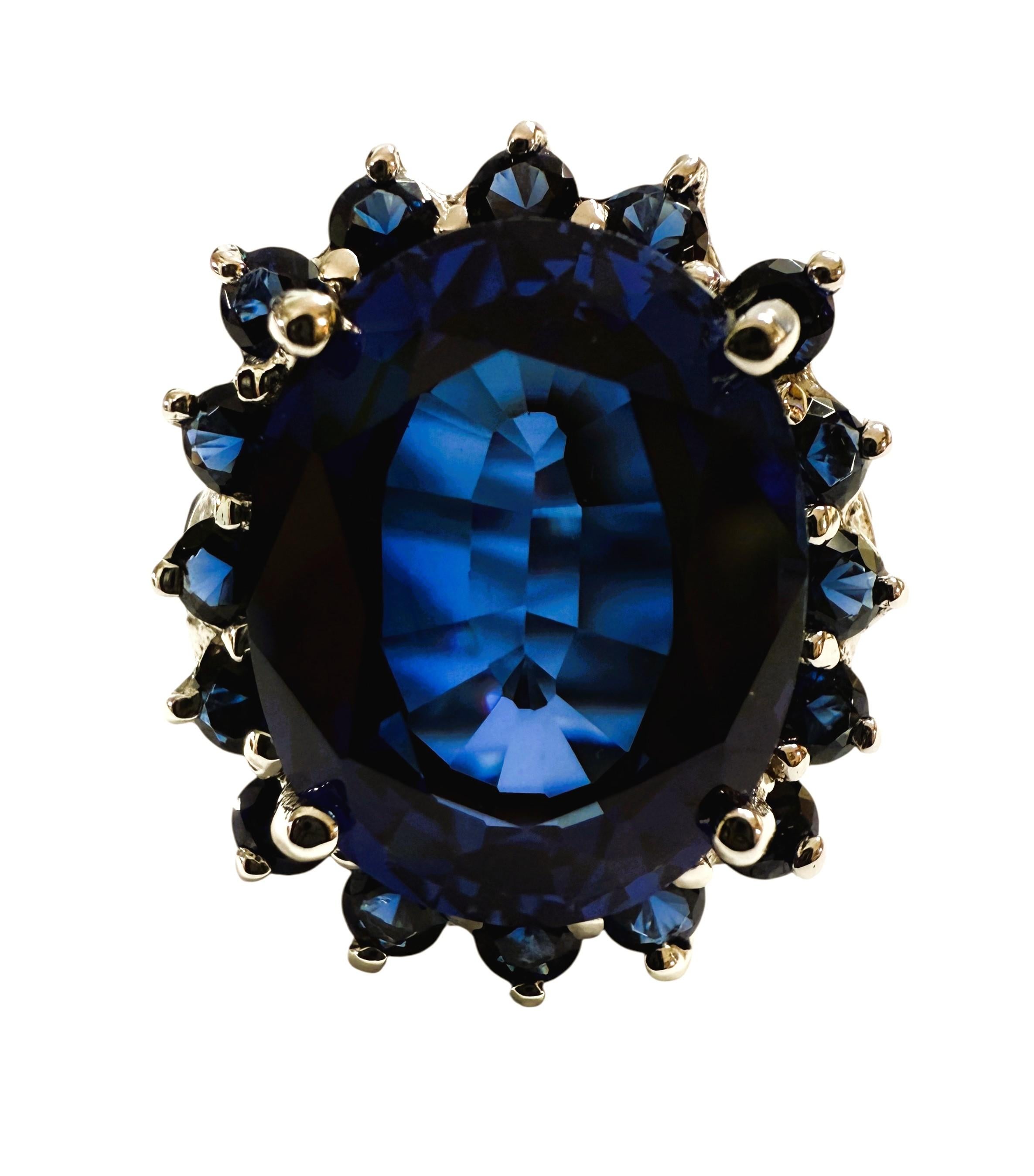 Questo anello è semplicemente bellissimo.  È una taglia 6,25.  La pietra proviene dallo Sri Lanka.  L'anello ha uno zaffiro ovale centrale di 11.70 carati.  Misura 14,6 x 11,5 mm.  È circondato da splendidi zaffiri blu taglio diamante.   Inoltre, ha