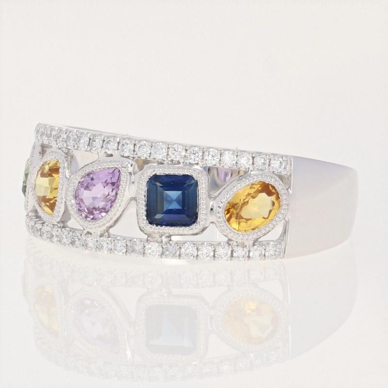 This fabulous NEW ring will refresh your wardrobe with a splash of luminous color! Composed of 14k white gold, this piece showcases five sparkling multi-color sapphires that are framed by ornate milgrain borders and accompanied by two rows of icy
