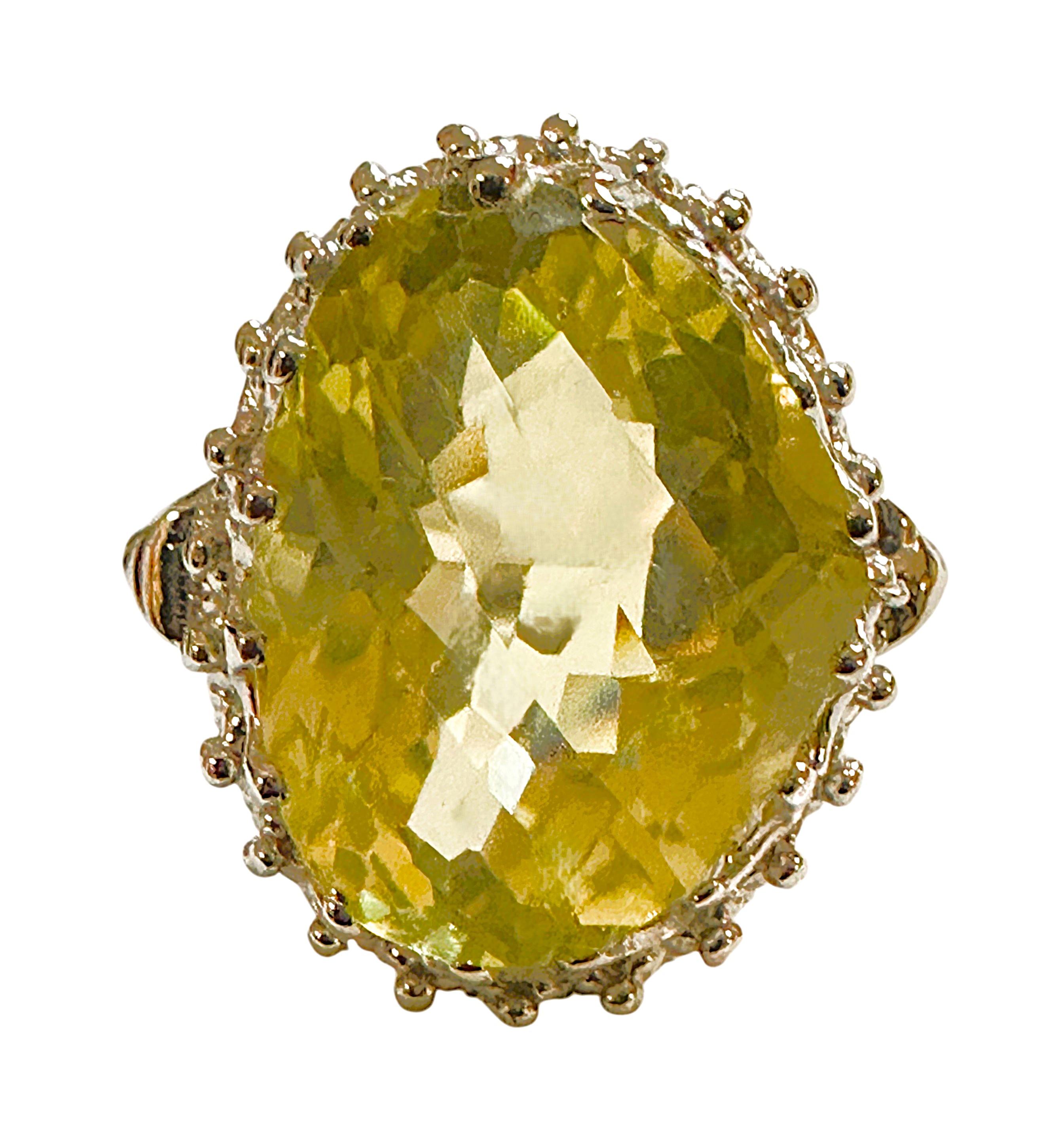 This is a very fetching ring.  This stone is from Brazil and just a beautiful color of yellow..  The ring is a size 6.5.   It is an faceted oval cut stone and is 16 x 12.5 mm.  It's set in a beautiful diamond cut  sterling silver crown setting.  The