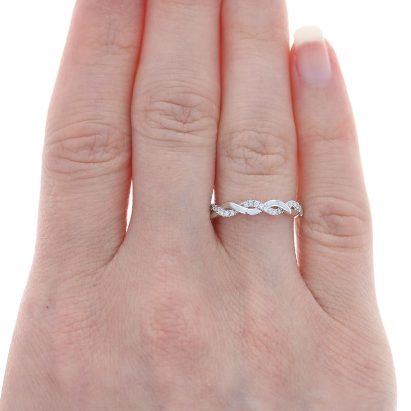 This captivating ring is destined to be treasured for a lifetime! Featuring an intertwined 