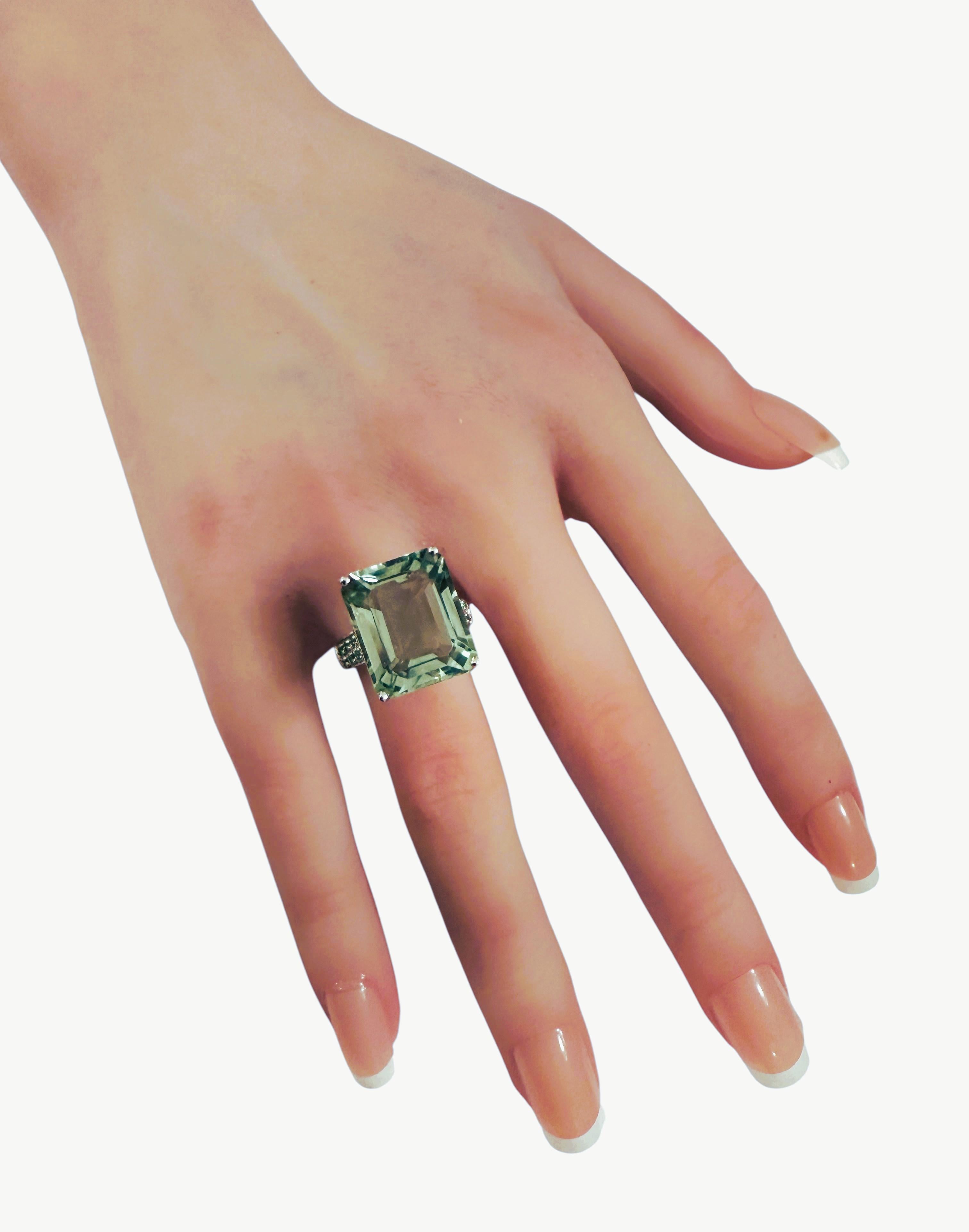 The ring is just stunning!  It is a size 6.25 This stone is from Africa.  It is a beautiful fancy cut baguette stone and is 14.2 carats.  It measures 16.8 x 13.8 mm and diamond cut Green Sapphire stones running down either side of the band.  They