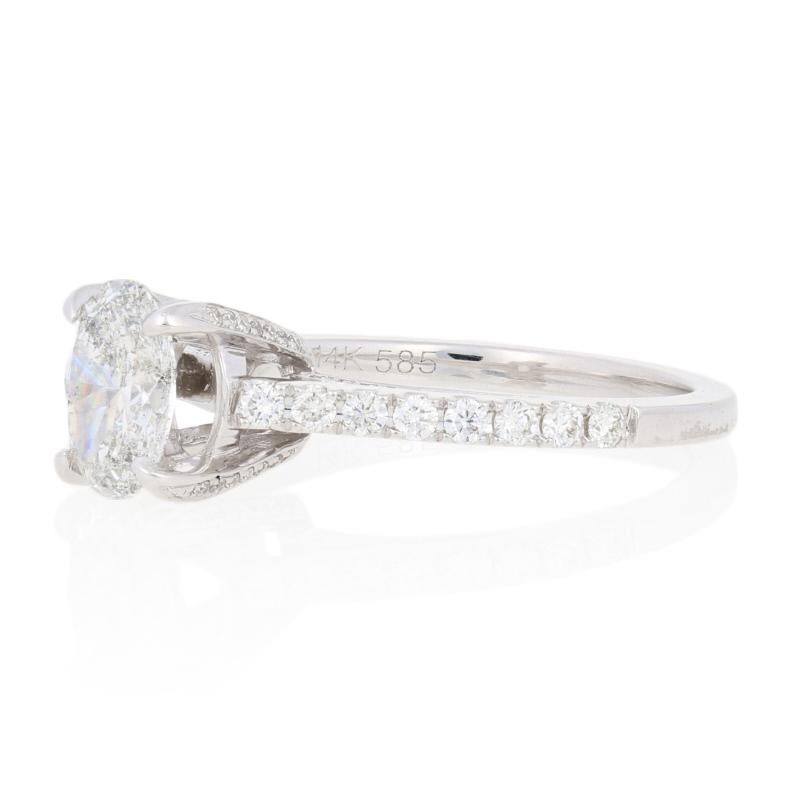 Surprise your love with the ring of her dreams! Featuring a cathedral-style bridge, this spectacular NEW engagement piece hosts an IGI-graded diamond solitaire accompanied by sparkling diamond accents set in 14k white gold. 

This ring is a size 6