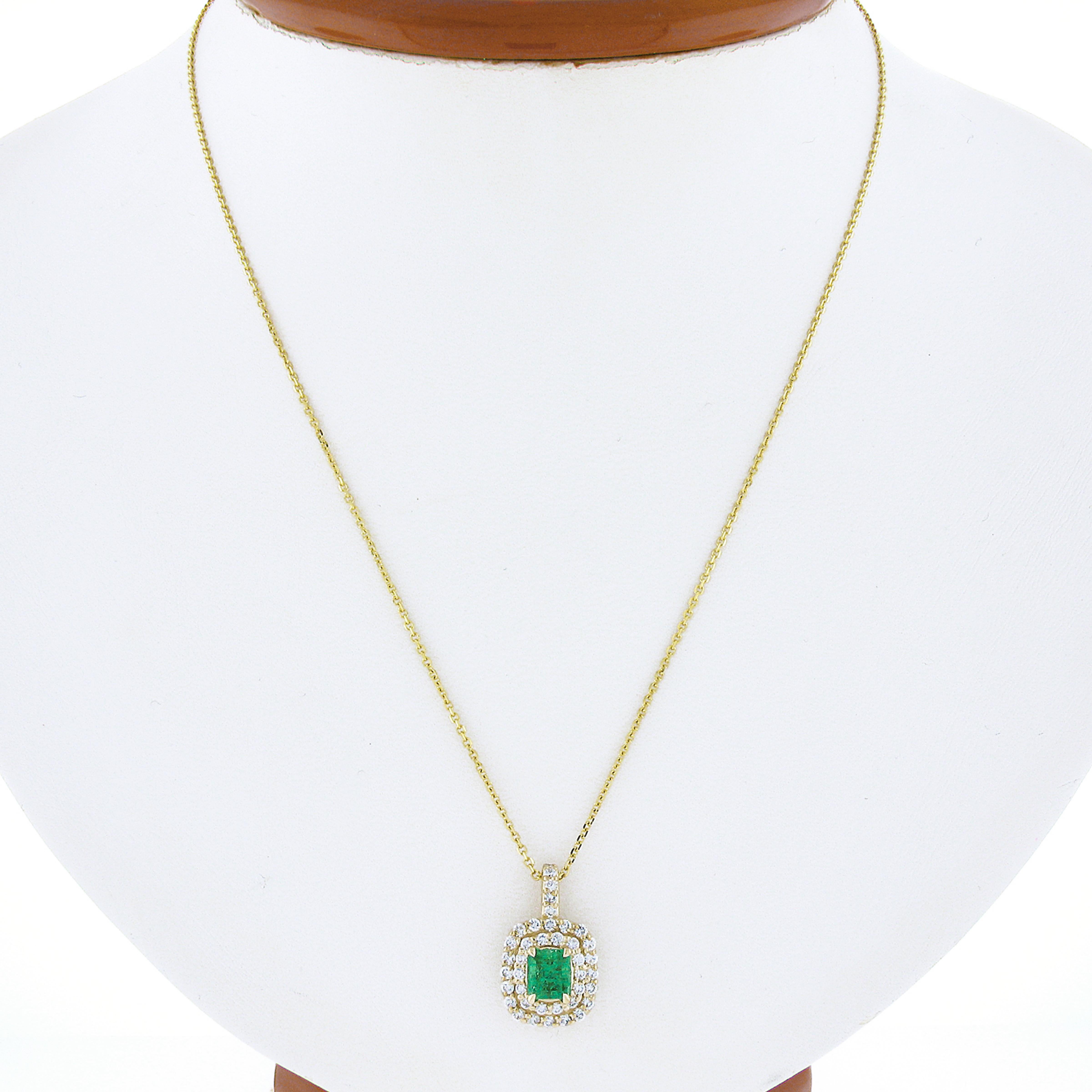 Here we have a gorgeous, custom made, emerald and diamond cushion shaped pendant newly crafted in solid 14k yellow gold. The fine quality emerald solitaire is GIA certified at weighing 0.77 carat, and displays truly wonderful vibrant green color