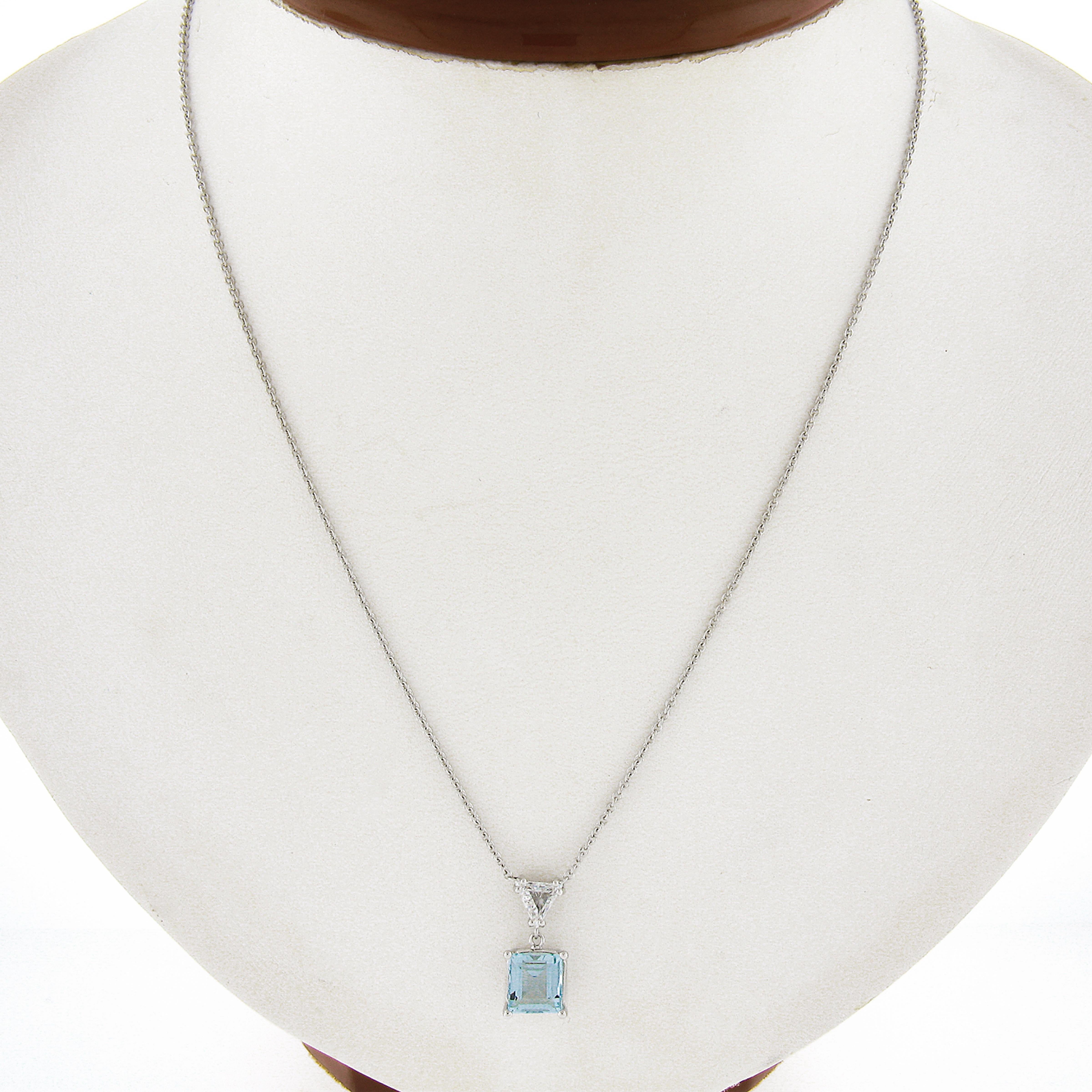 You are looking at a new custom simple and elegant styled aquamarine diamond dangle pendant necklace crafted in solid 14k white gold. The aquamarine is square step cut and neatly prong set in an open basket setting. This stunning petite solitaire
