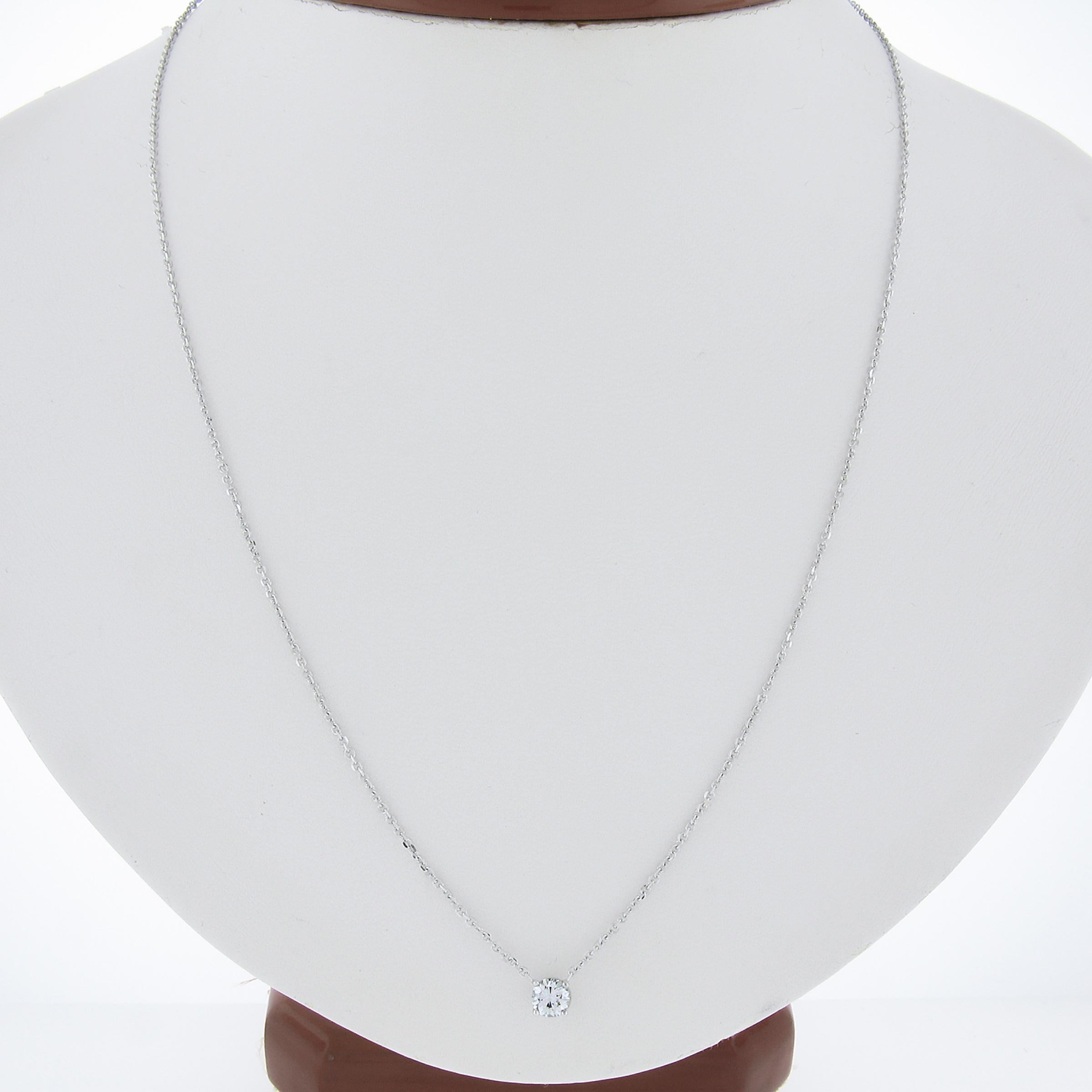 This new gorgeous classic pendant necklace that is crafted in solid 14k white gold and features a round brilliant cut diamond solitaire neatly prong set at the center of an open basket setting. The fine diamond weighs exactly 0.33 carats and