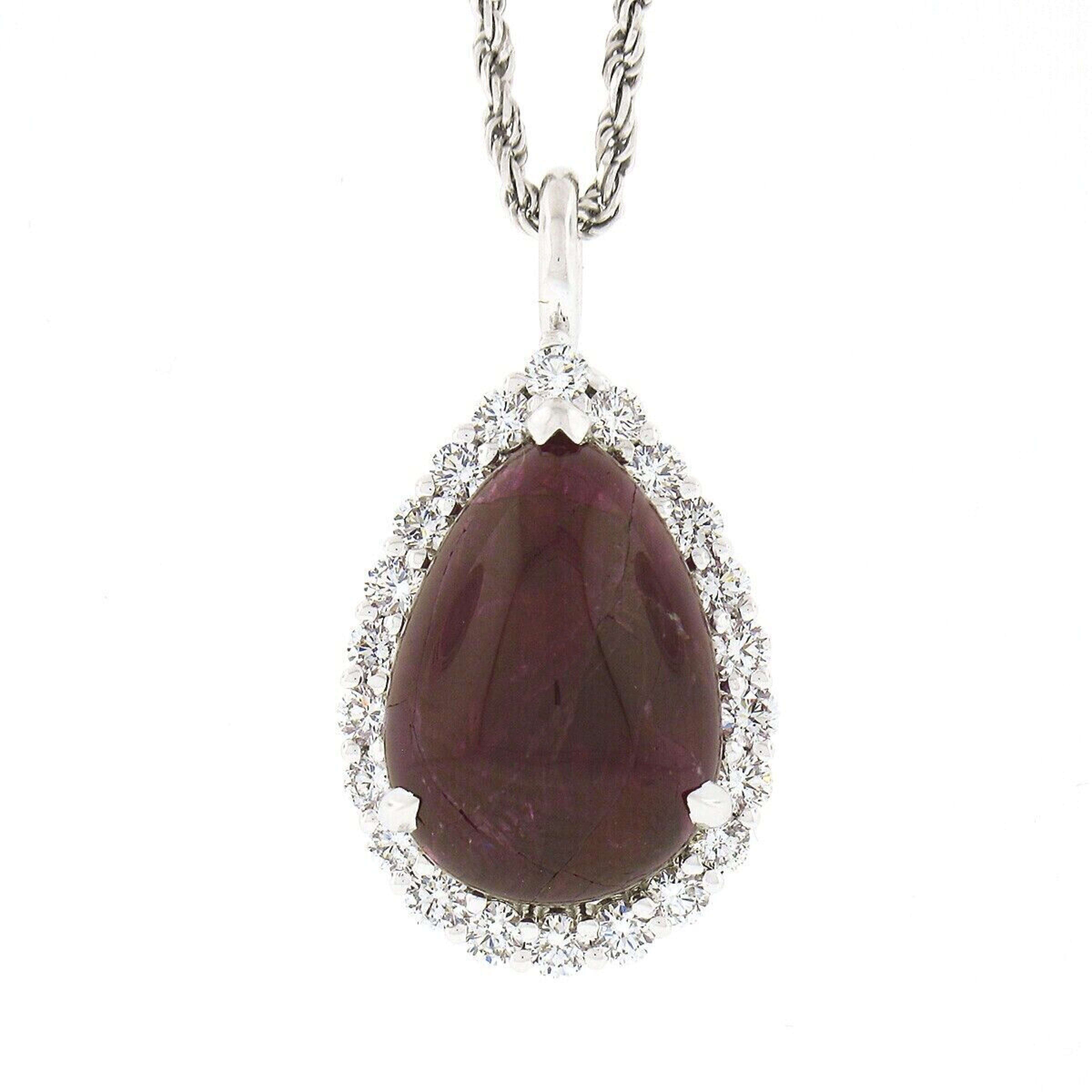 Here we have a gorgeous, custom made, ruby and diamond teardrop pendant necklace that is newly crafted in solid 14k white gold. The fine quality ruby solitaire is GIA certified with a pear cabochon cut, displaying the most attractive and truly rich