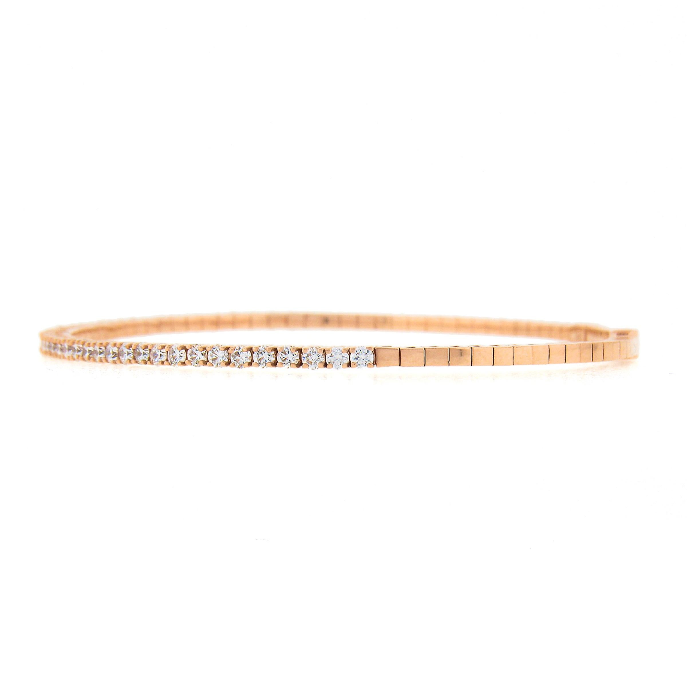 This beautiful, semi-flexible, bangle bracelet was newly crafted in solid 14k rose gold and features very fine quality diamonds neatly set across its top. These fiery diamonds are round brilliant cut and total exactly 1.14 carats, displaying