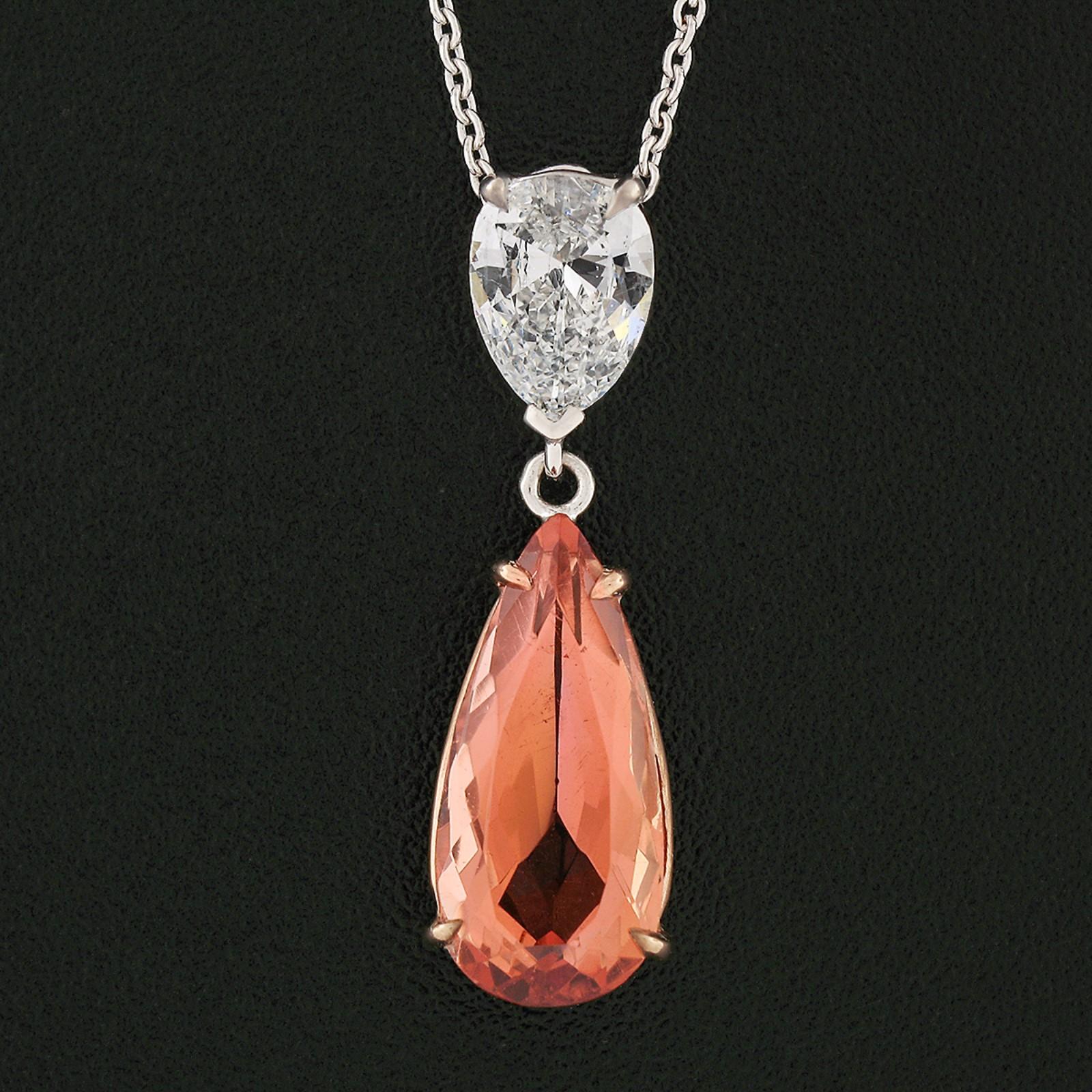 Here we have a very elegant and modern orange topaz and diamond dual teardrop pendant, newly crafted in custom designed solid 14k gold baskets. The pendant features a stunning, 2.58 carats, GIA certified natural topaz stone displaying glowing and
