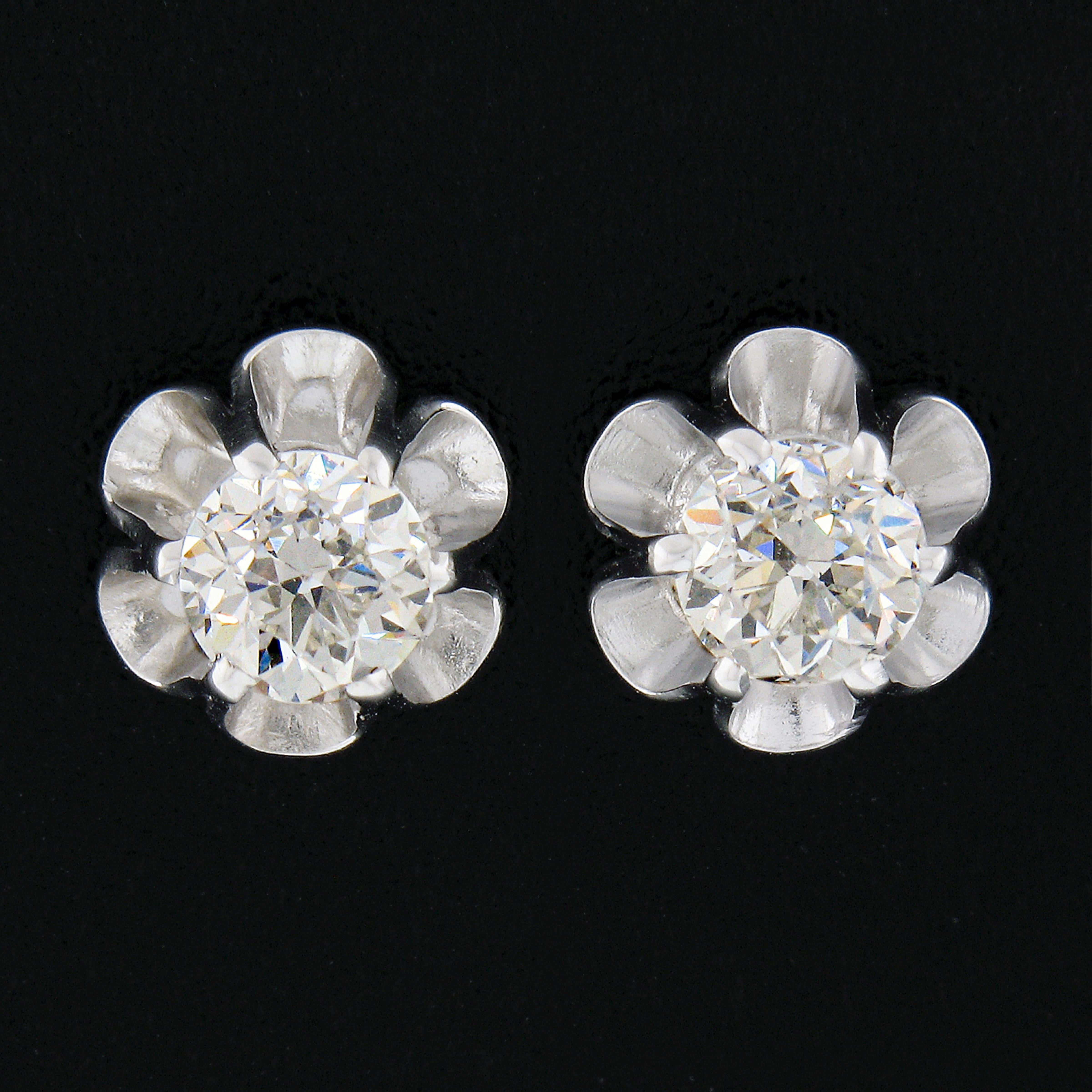 These gorgeous stud earrings are crafted in solid 14k white gold and feature, antique, old European cut diamonds that are elegantly set in brand new buttercup prong basket settings. The stunning diamonds total 0.85 carats in weight and are amazingly