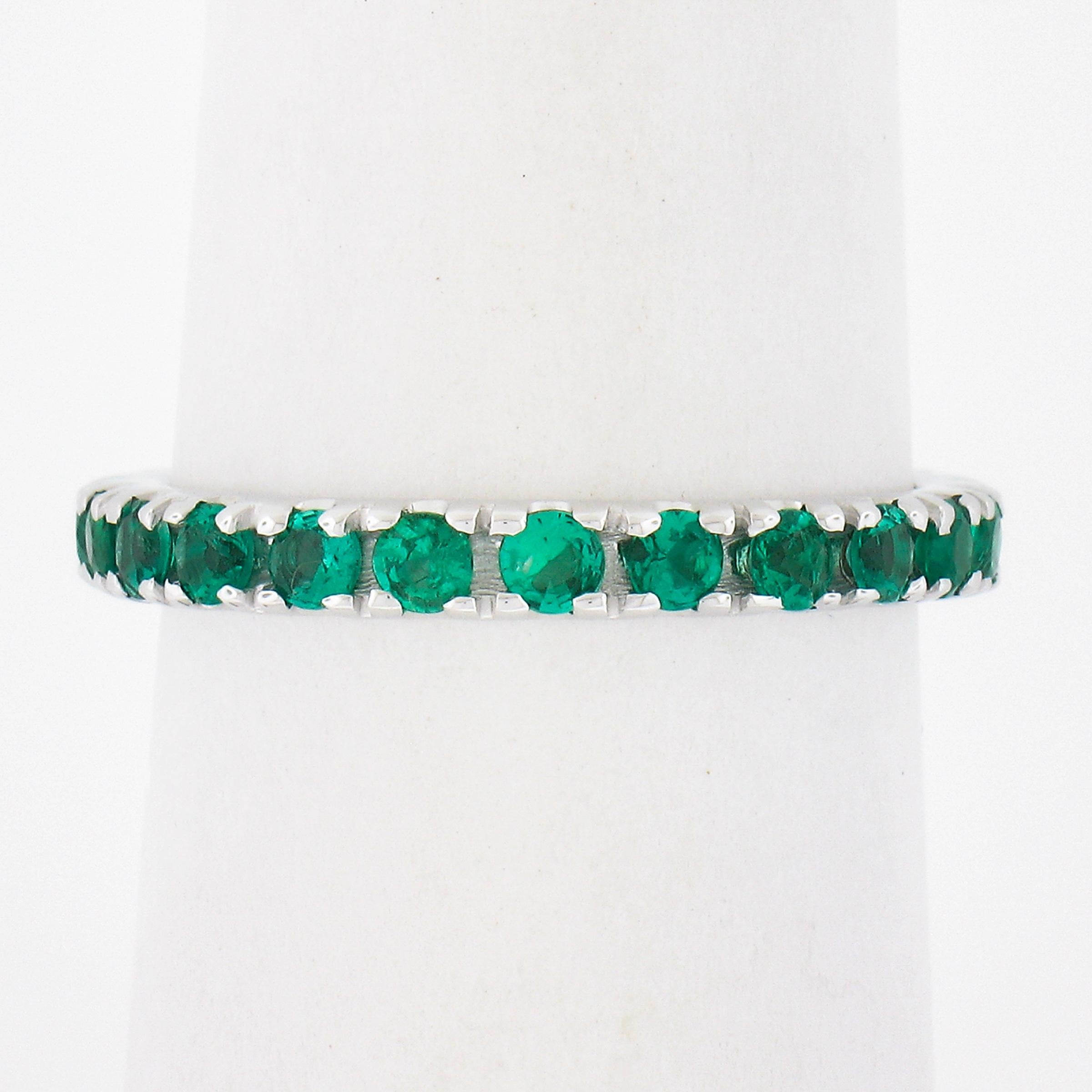 --Stone(s):--
(23) Natural Genuine Emeralds - Round Brilliant Cut - Prong Set - Vivid Green Color 
Total Carat Weight:	1.10 (exact)

Material: Solid 14k White Gold
Weight: 2.39 Grams 
Ring Size: 6.5 (We can NOT custom size these rings.)
Ring Width: