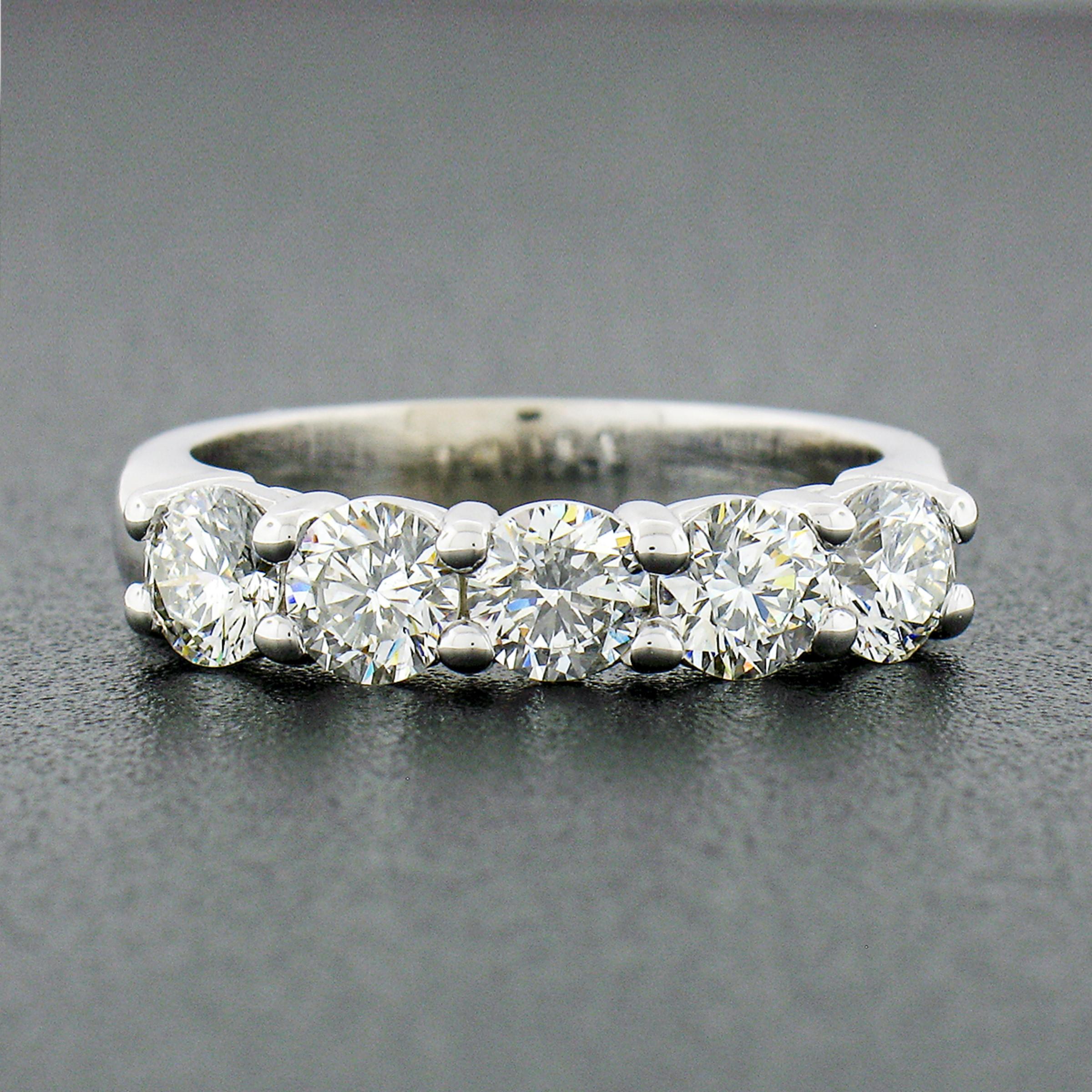This magnificent diamond band ring was newly crafted from solid 14k white gold and features 5 round brilliant cut diamonds neatly shared-prong set across its top. Each diamond shows a nice large size, weighing exactly 1.38 carats total, and display