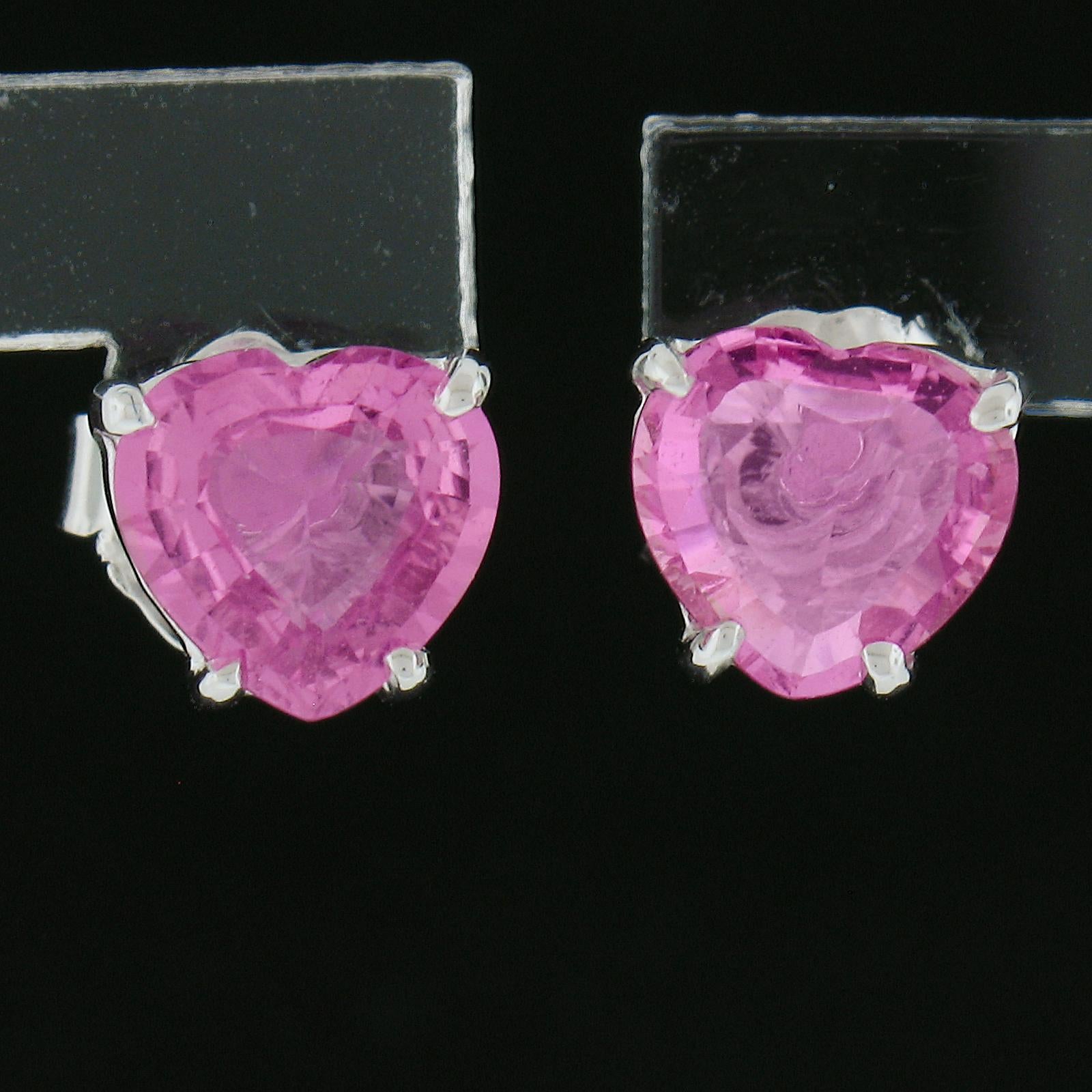 --Stone(s):--
(2) Natural Genuine Sapphires - Heart Brilliant Cut - Prong Set - Vivid Pink Color 
Total Carat Weight:	1.44 (exact.)

Material: 14k Solid White Gold
Weight: 1.16 Grams
Backing: Post Back w/ Butterfly Closure (pierced ears are