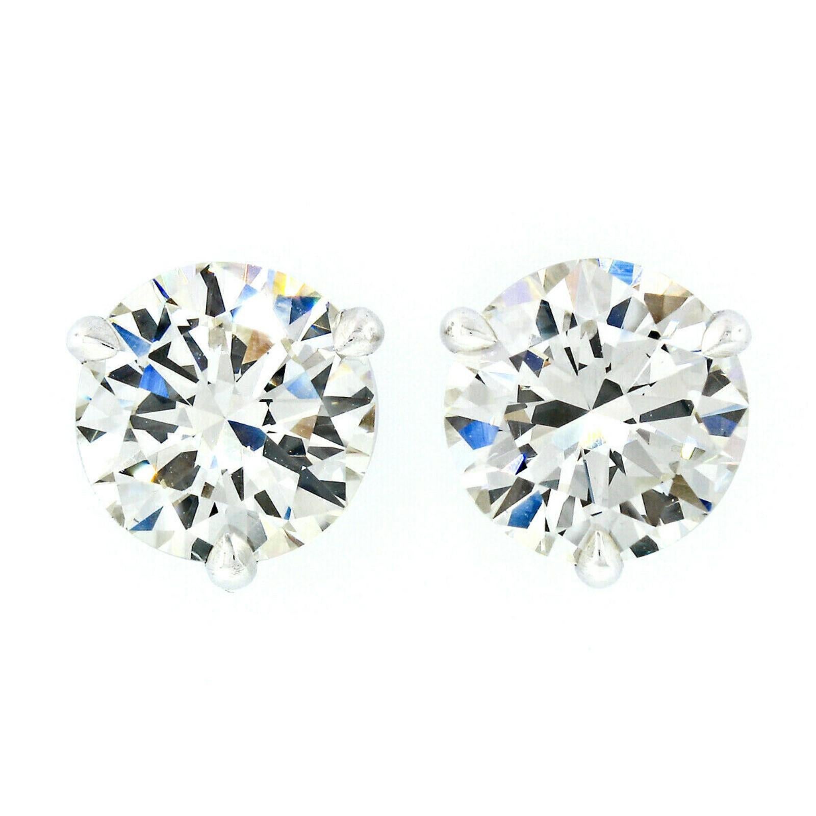 This stunning pair of diamond stud earrings was newly crafted from solid 14k white gold and features two exceptionally brilliant and fiery GIA certified round diamonds. The diamonds total exactly 3.03 carats in weight with K/L color - facing up