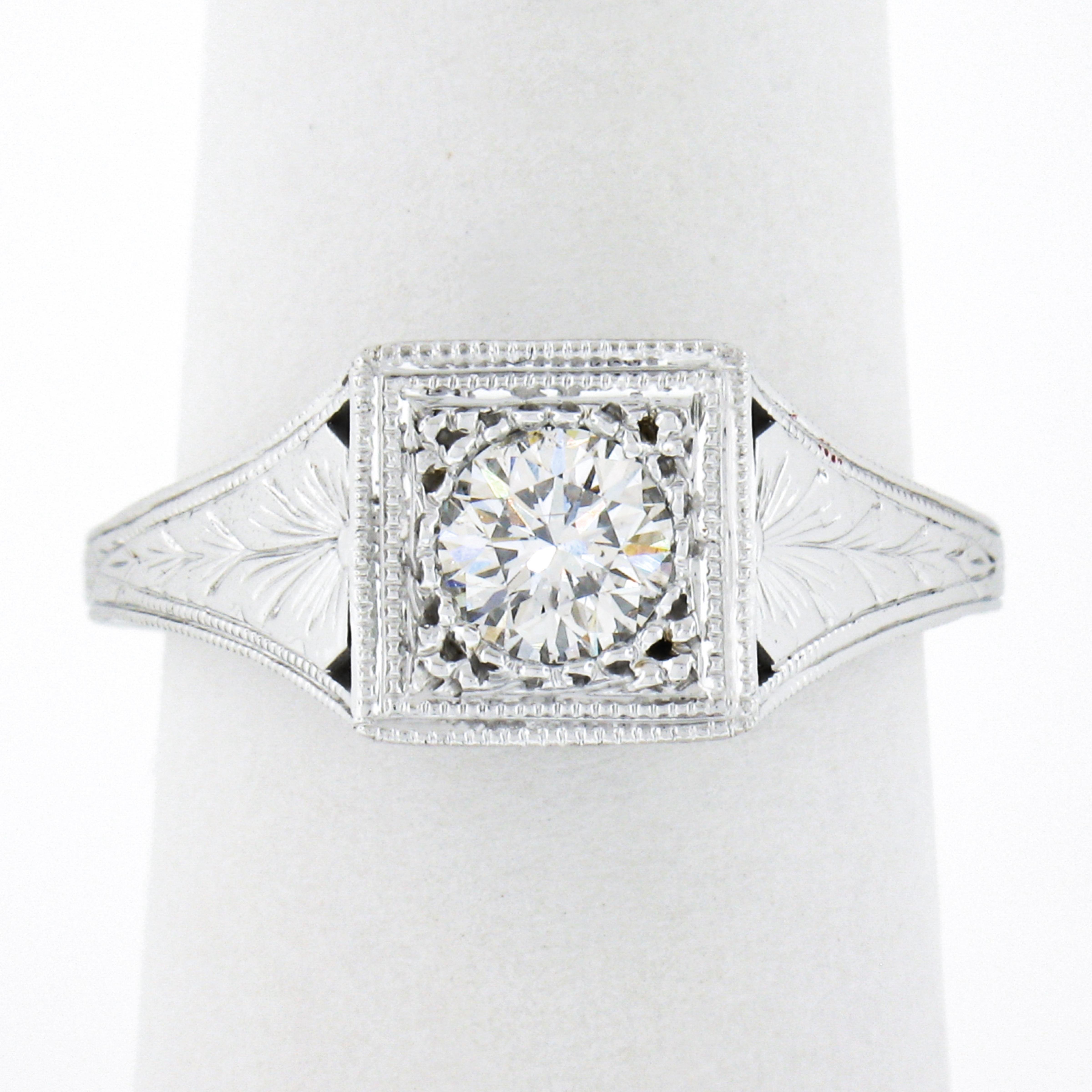 Here we have an incredible, brand new ring crafted from solid 14k white gold. The ring features a GIA certified round brilliant cut diamond neatly pave set at the center of the milgrain etched squared top. The stunning solitaire weighs exactly 0.50