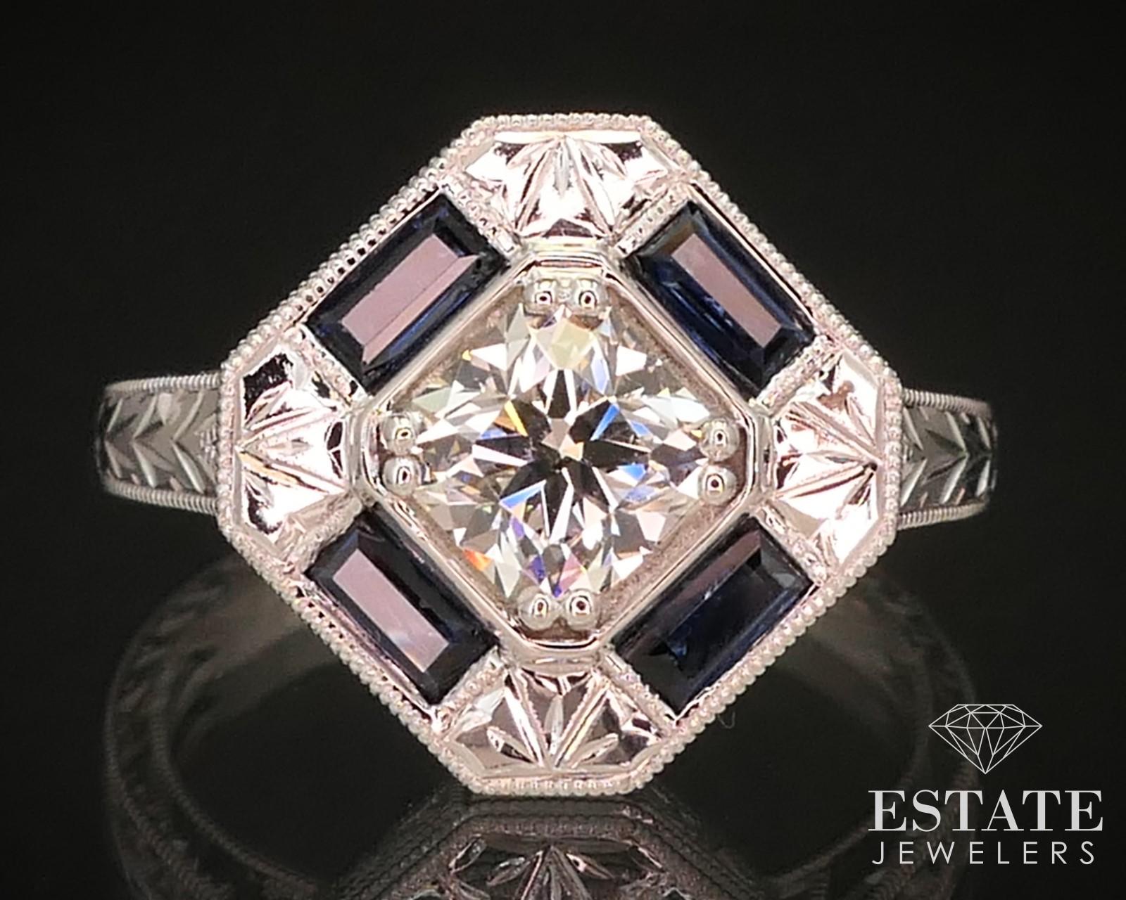 This beautiful new engagement ring is inspired by antique art deco designs, and features a laser-inscribed AGS .75ct cushion cut diamond, with VS2 in clarity and I in color. Accompanying the main stone are approximately .75ctw of natural sapphire