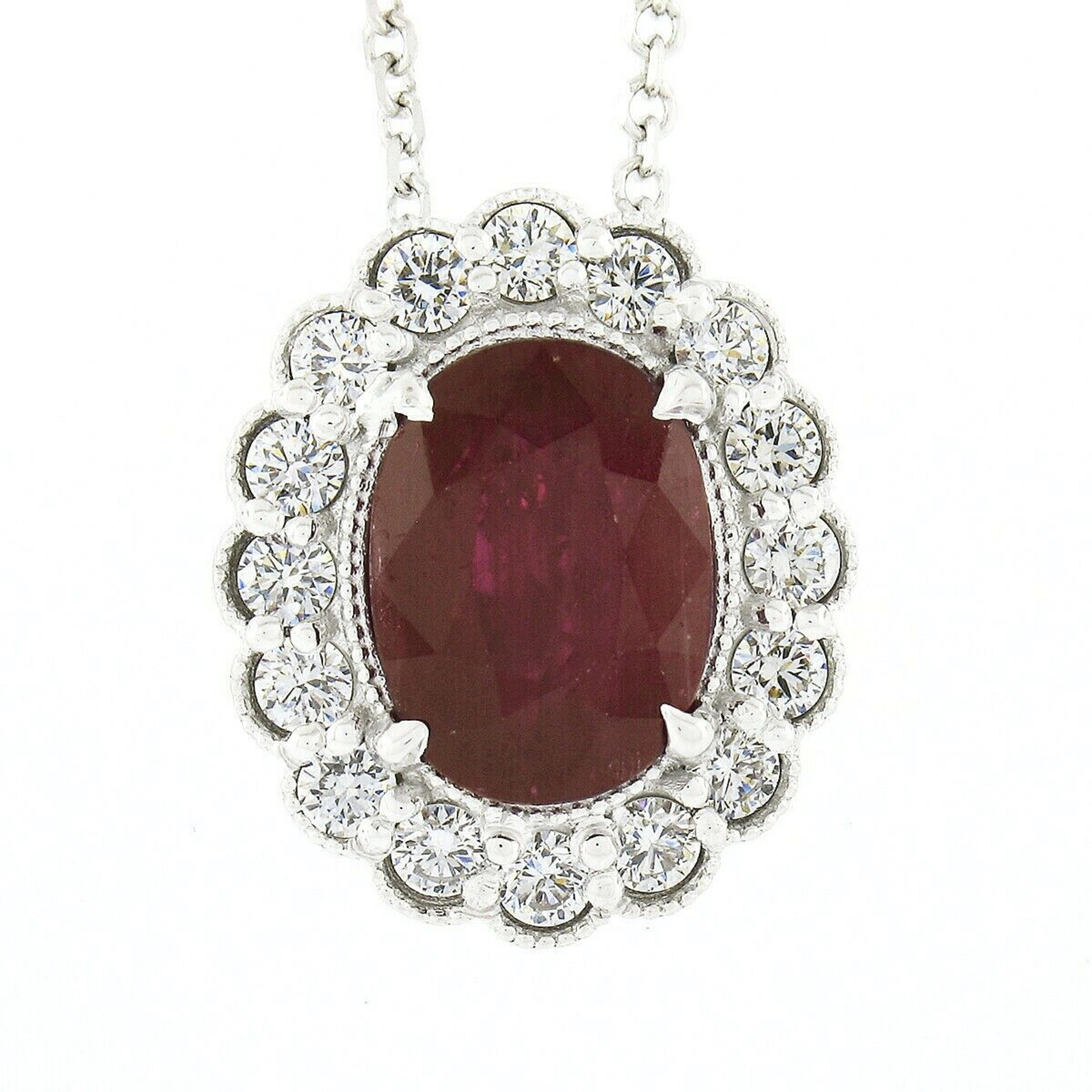 Here we have a gorgeous, brand new, and custom made pendant necklace crafted in solid 14k white gold and features a very fine oval brilliant cut ruby solitaire neatly set at the center of a stunning diamond halo. The ruby is certified as weighing