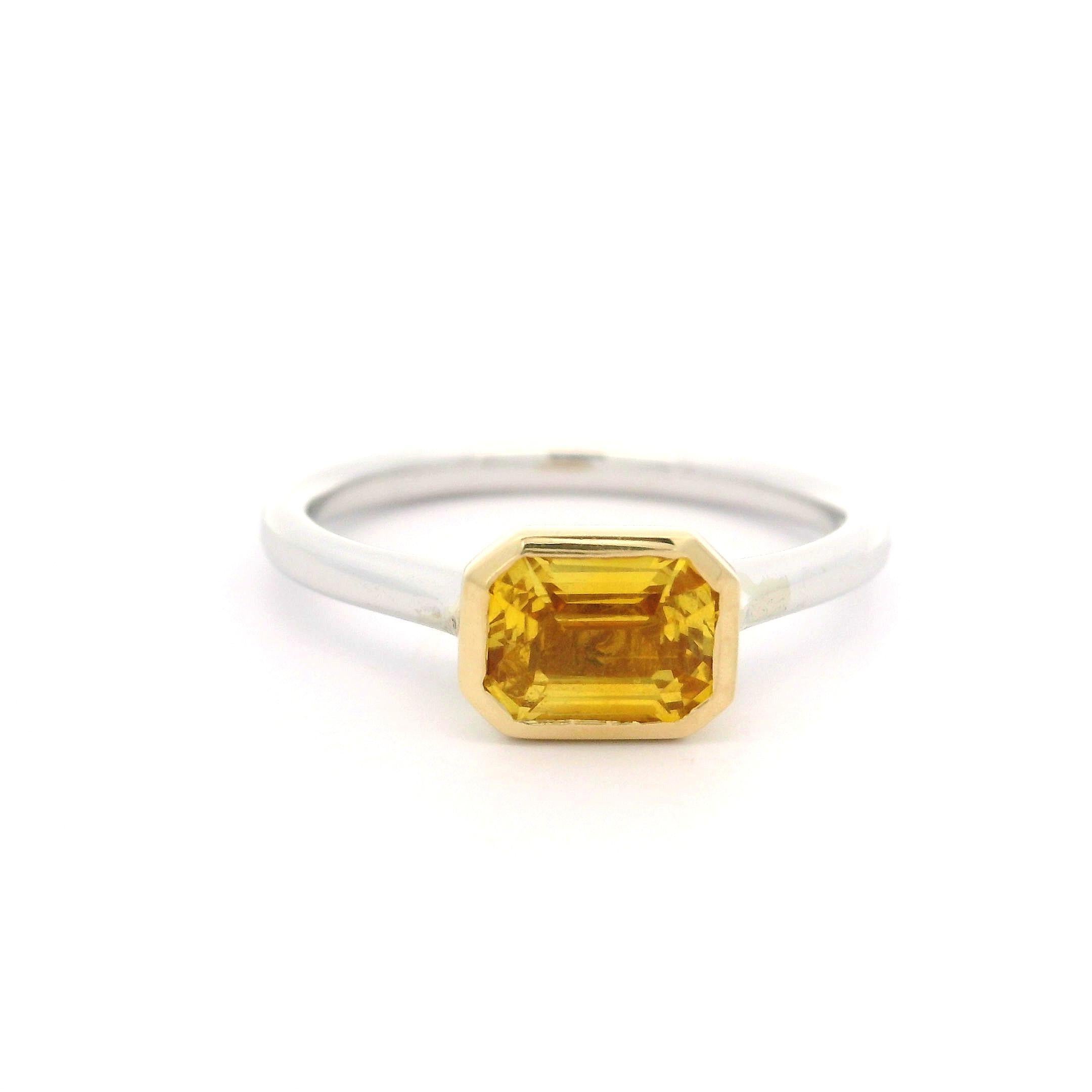 --Stone(s):--
(1) Natural Genuine Sapphire - Emerald Cut - Bezel Set - Deep Yellow Color - 1.09ct (exact)
Total Carat Weight: 1.09 (exact)

Material: Solid 14k White Gold w/ Yellow Gold Head
Weight: 2.91 Grams
Ring Size: 6.5 (Fitted on a finger. We
