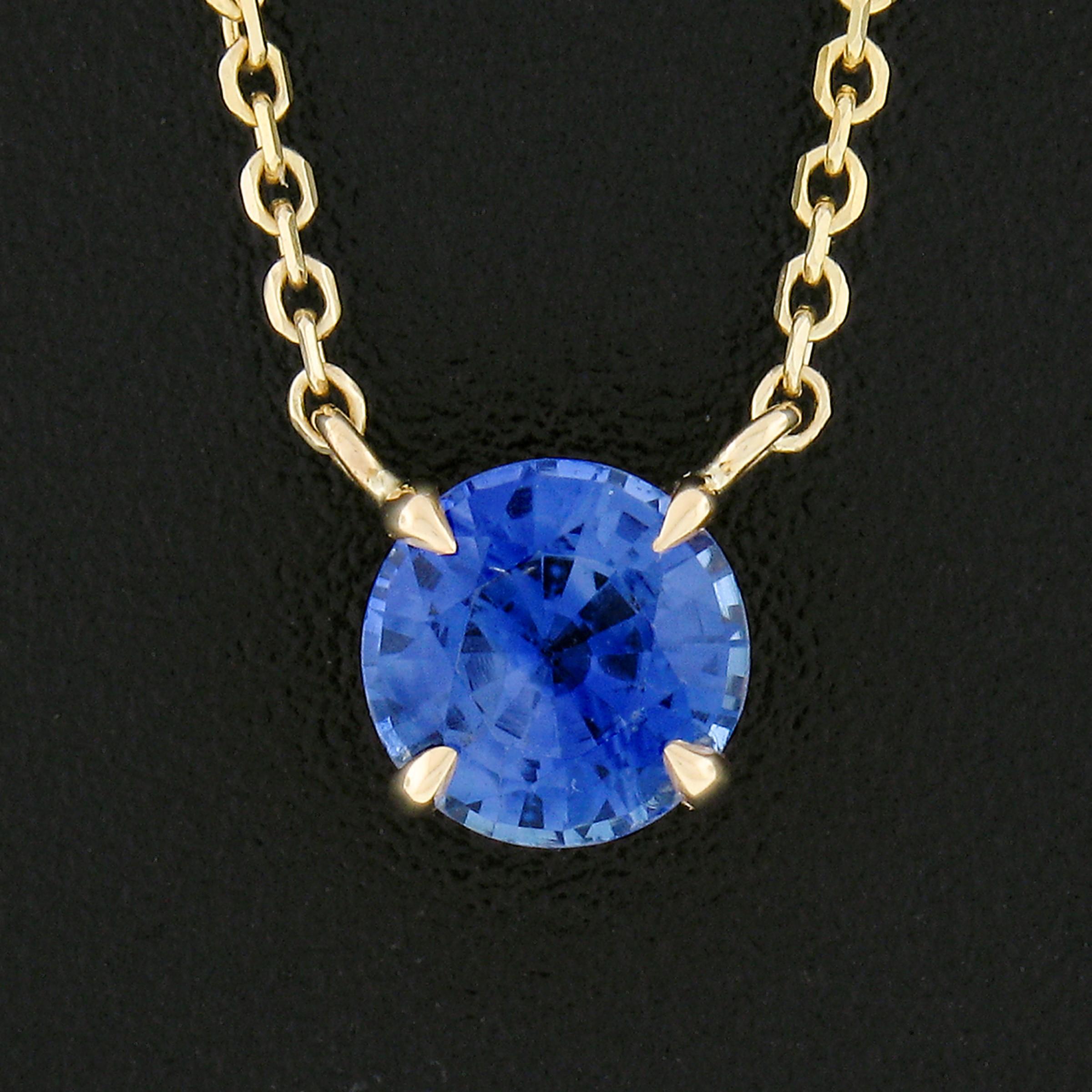 You are looking at a simple and classically styled sapphire solitaire pendant newly crafted in solid 14k yellow gold. The sapphire in this pendant displays an absolutely gorgeous, medium, brilliant blue color with non-stop sparkle due to its amazing